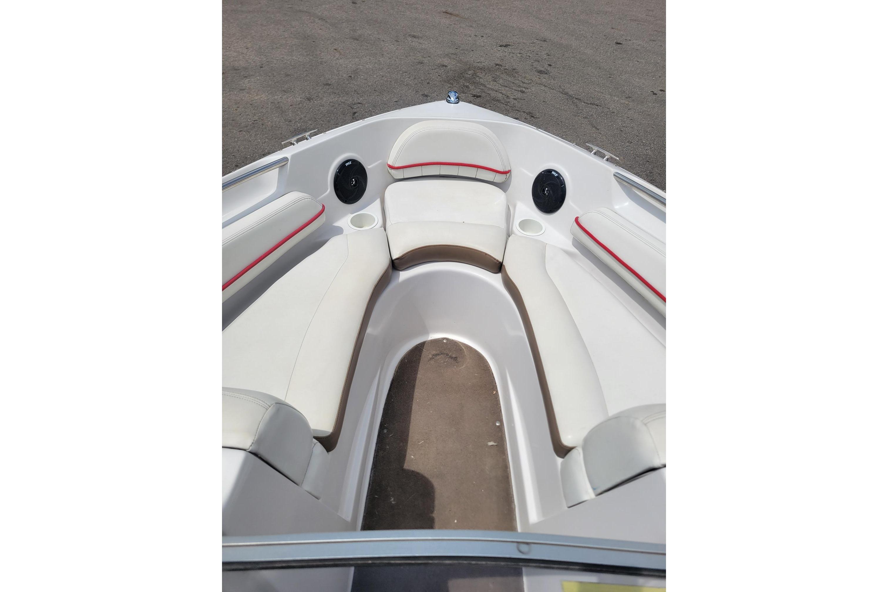 2007 Four Winns 200 Horizon boat interior with white seating and red accents.