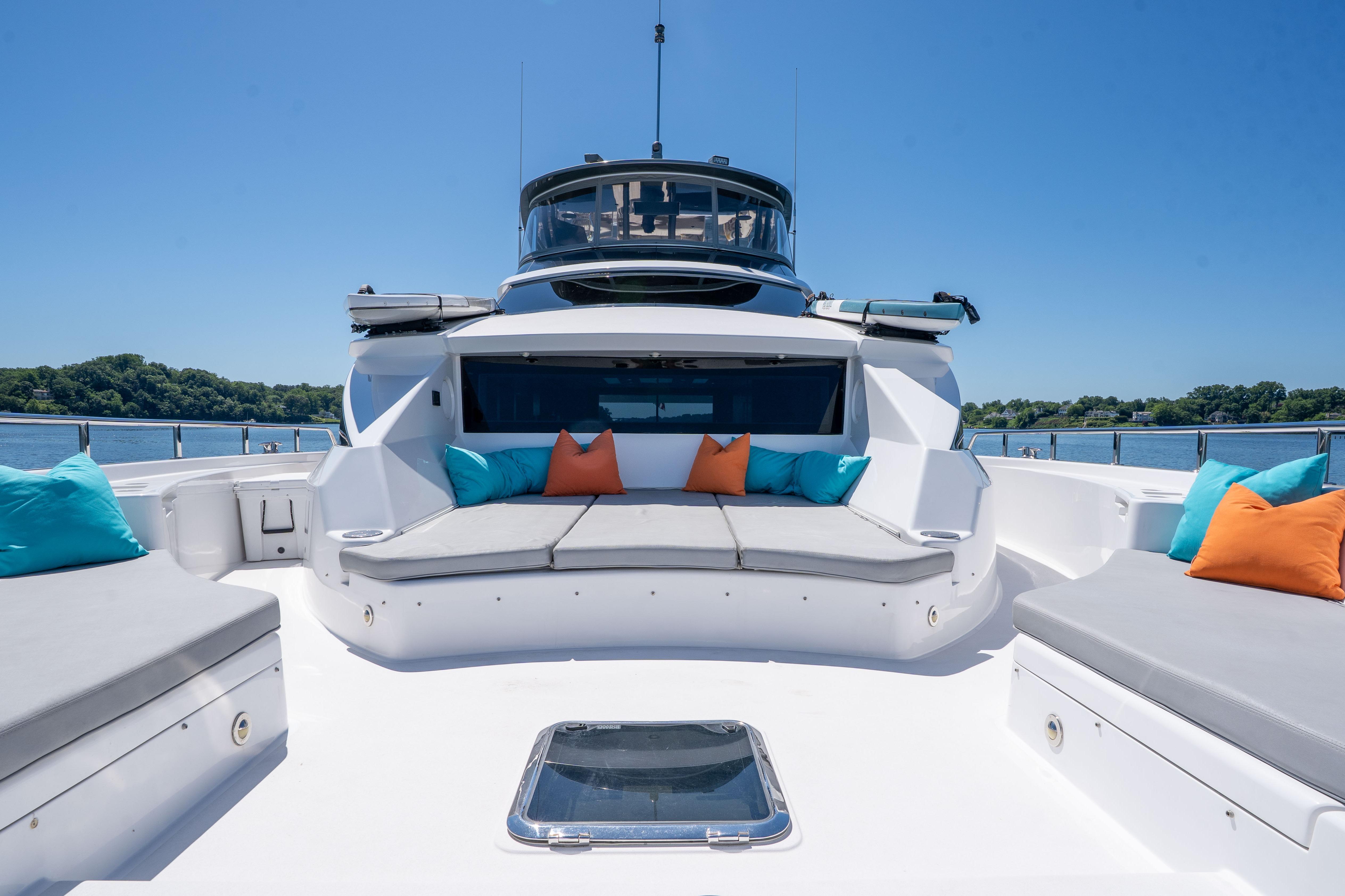 Luxurious 2021 Hatteras M75 Panacera yacht deck with plush seating and vibrant cushions.
