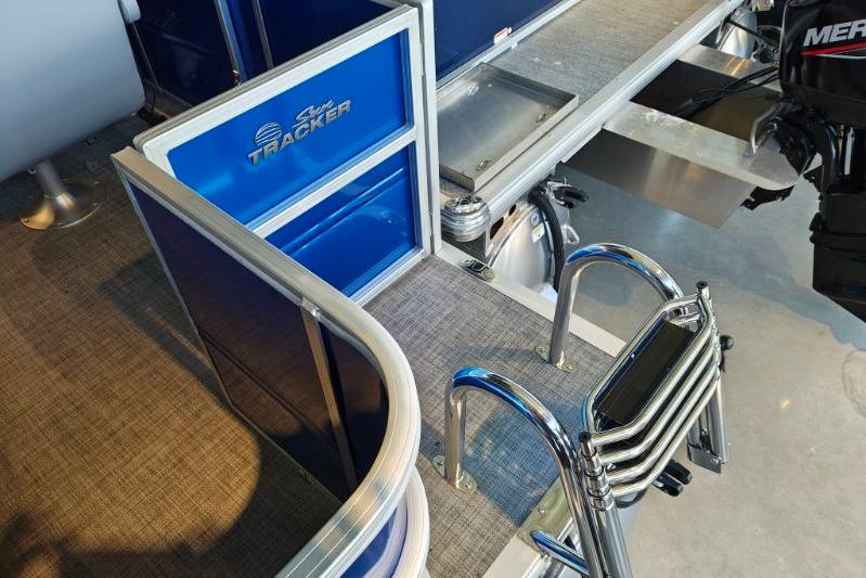 2026 Sun Tracker Party Barge 18 DLX interior with ladder and engine view.