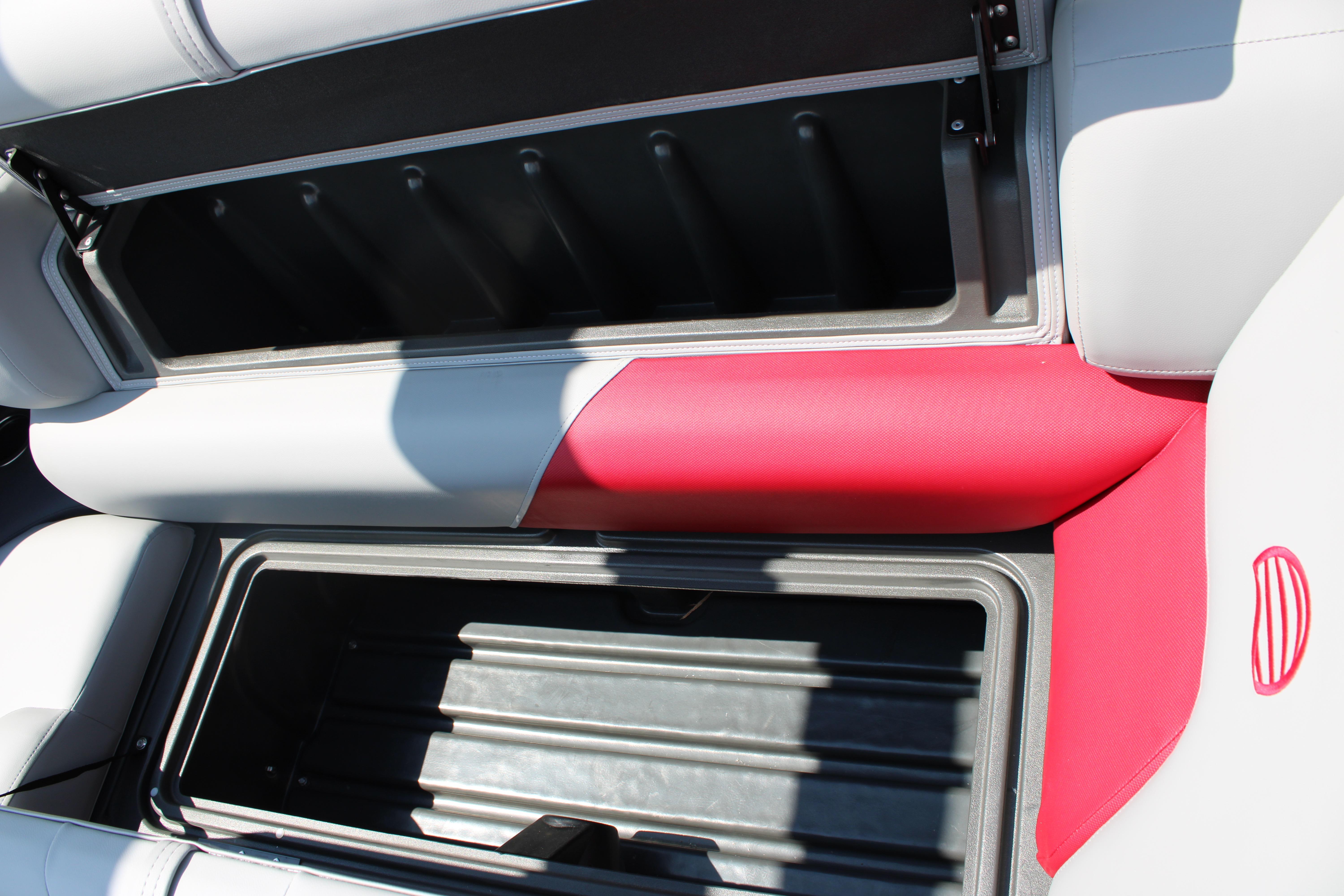 2026 Sun Tracker Party Barge 20 DLX storage compartment with red and gray seating.