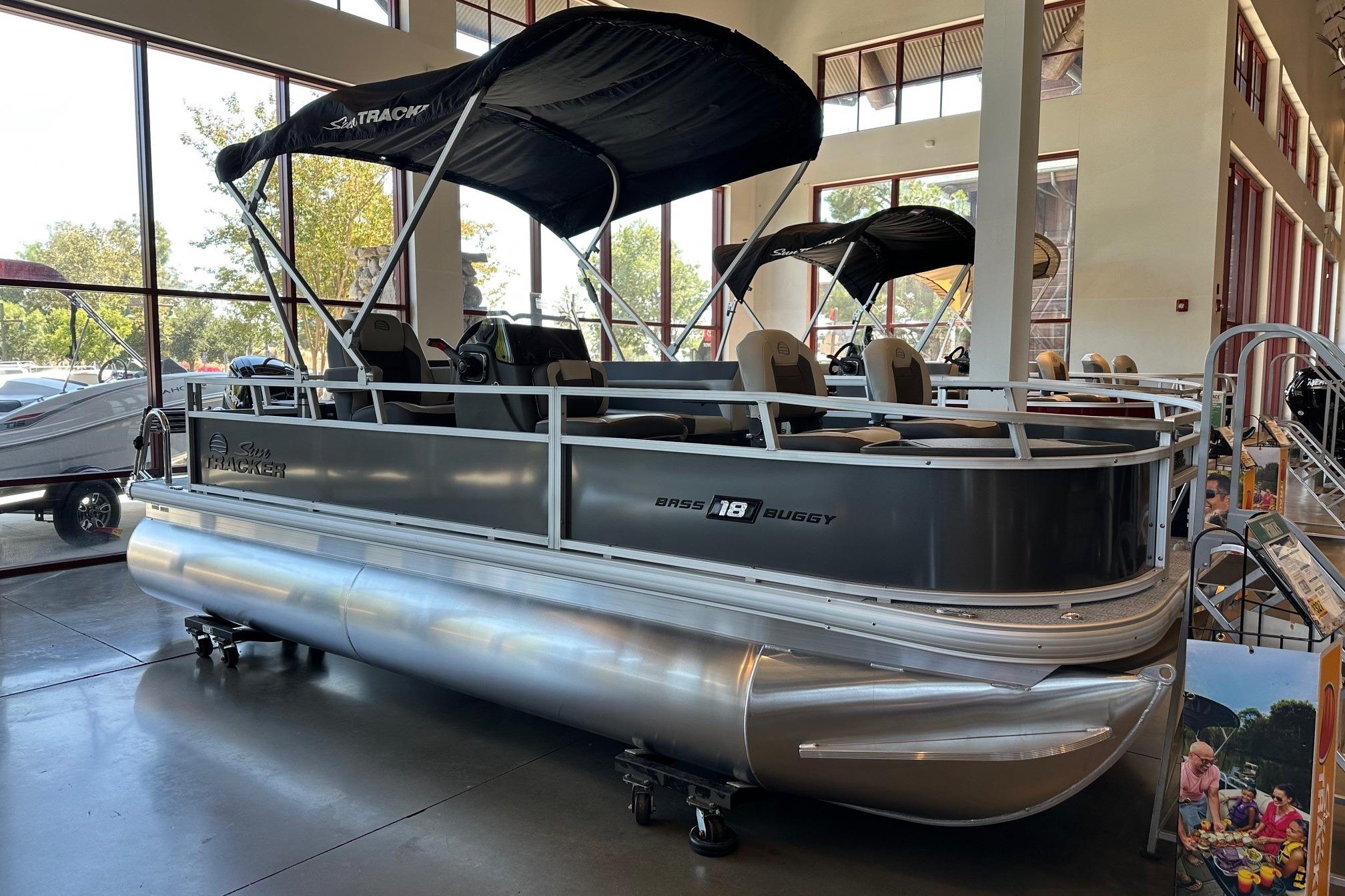 2026 Sun Tracker Bass Buggy 18 DLX pontoon boat displayed indoors.