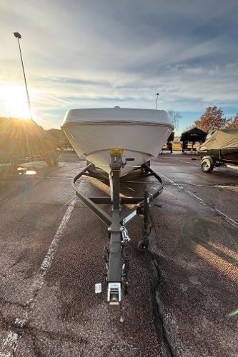 2024 Tahoe T21 boat on trailer in parking lot at sunset.