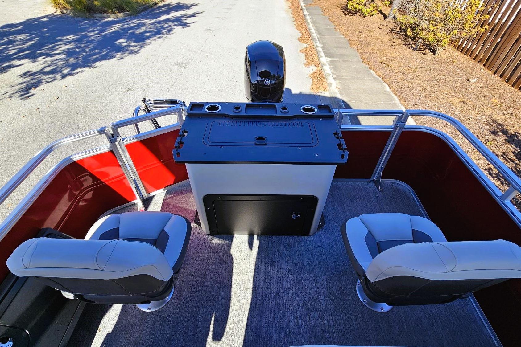 2026 Sun Tracker Fishin' Barge 22 DLX interior with seating and control panel.