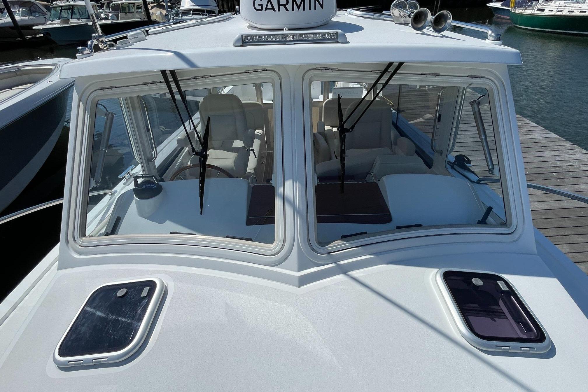 2023 MJM 35 boat with Garmin equipment, docked at a marina.