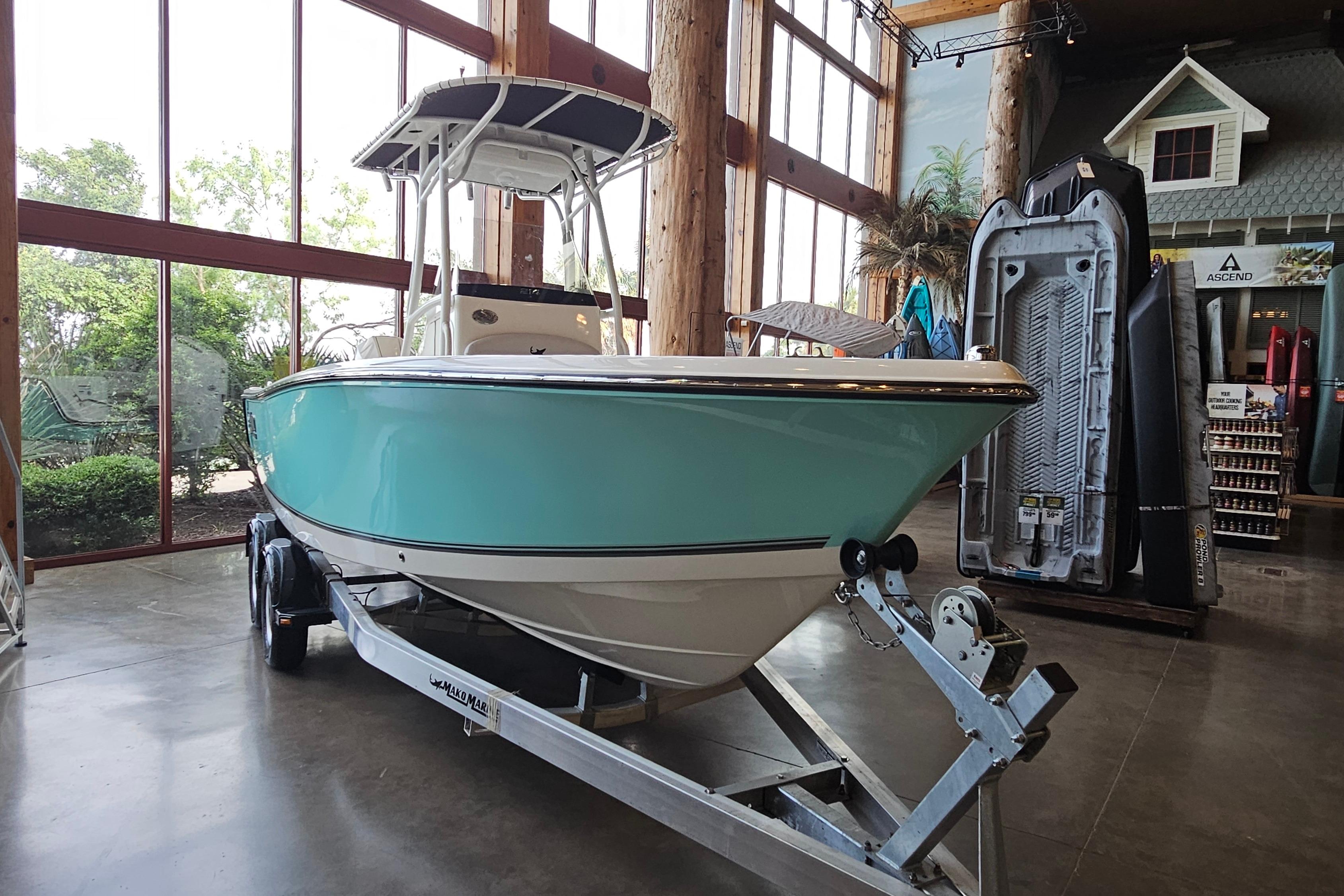 2025 Mako 214 Center Console boat displayed indoors on a trailer.