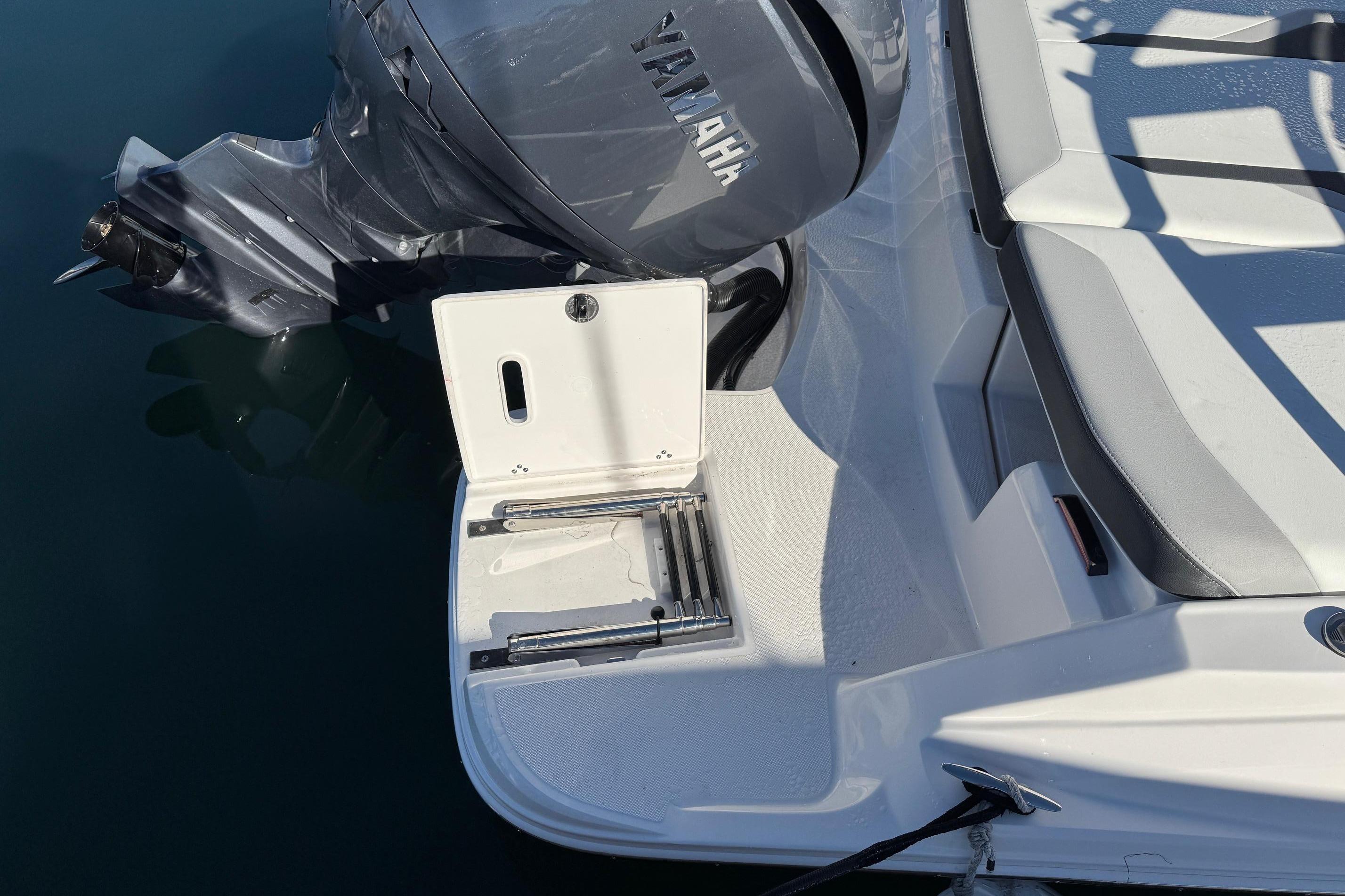 2026 Regal 21 OBX boat with Yamaha outboard motor and swim platform.