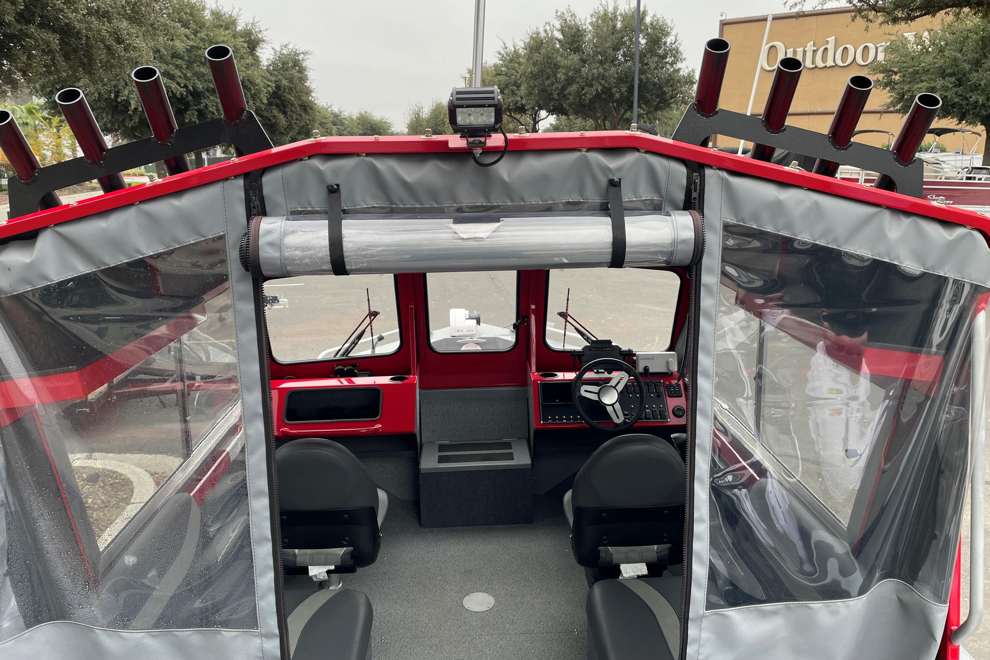 Interior view of 2024 Spartan 200 Astoria boat with steering wheel and seating.