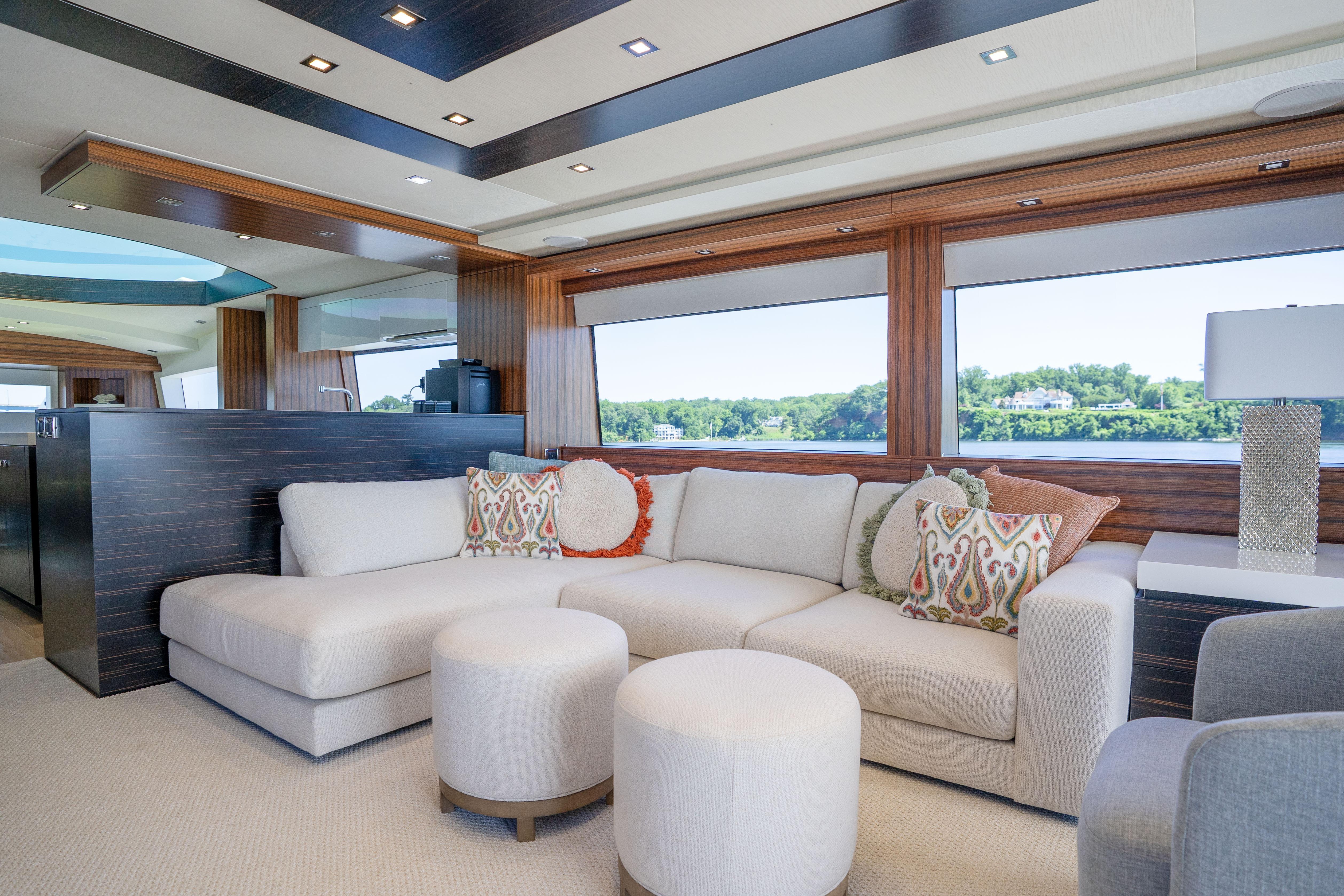 Luxurious interior of 2021 Hatteras M75 Panacera yacht with elegant seating and scenic windows.