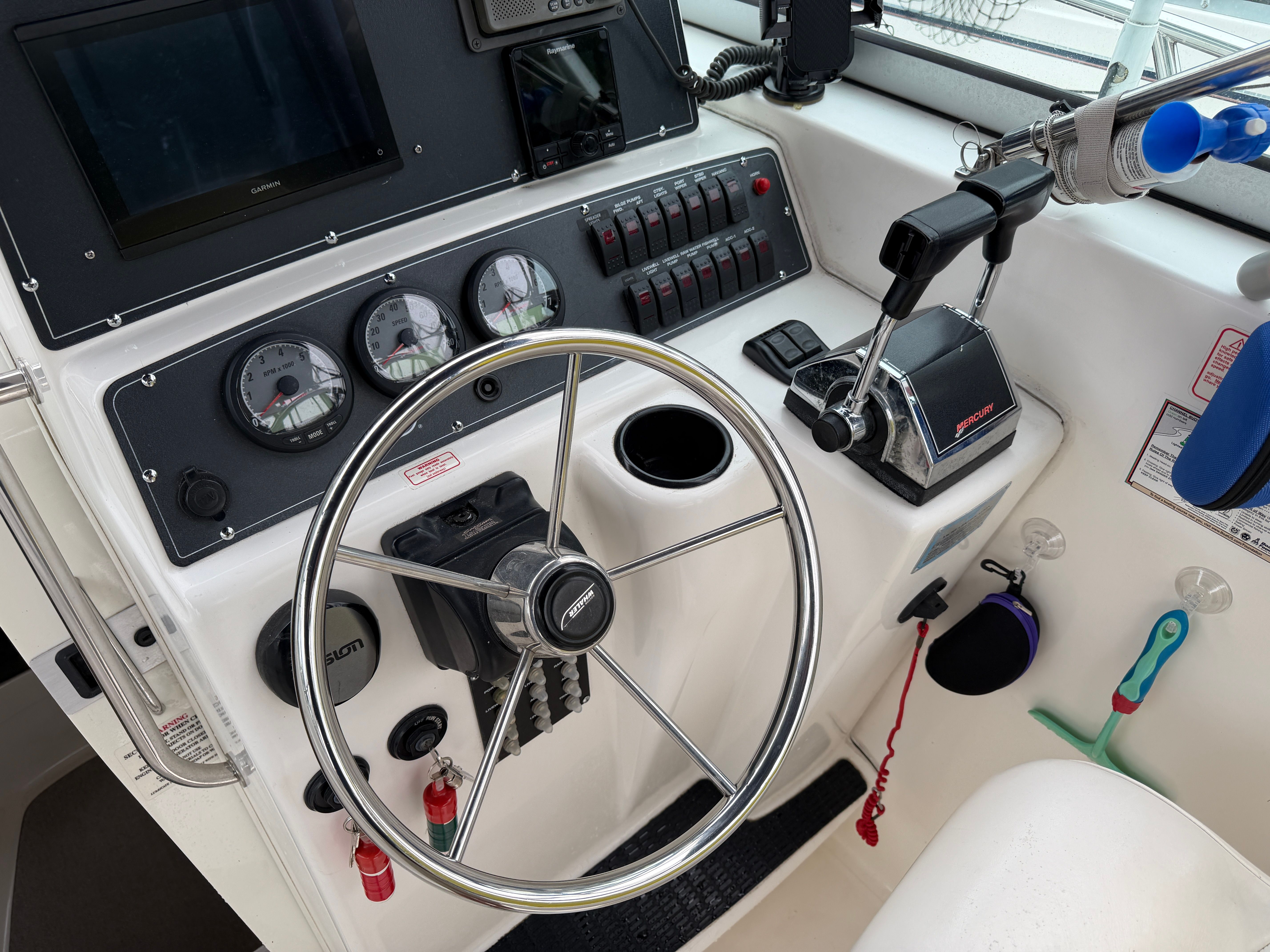 The image shows the helm of a 2001 Boston Whaler 26 Conquest boat.