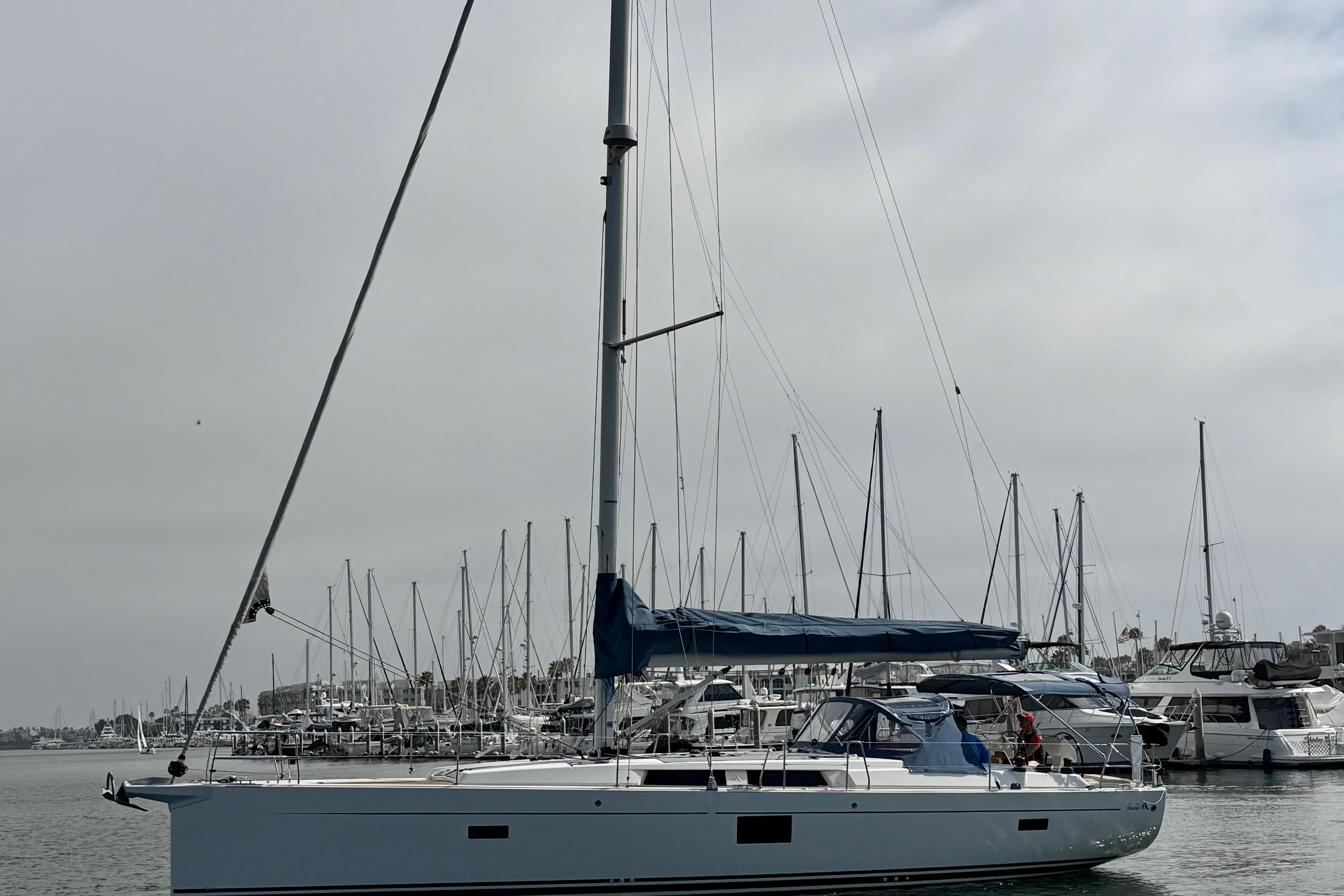 2016 Hanse 455 sailboat docked in a marina, surrounded by other boats.