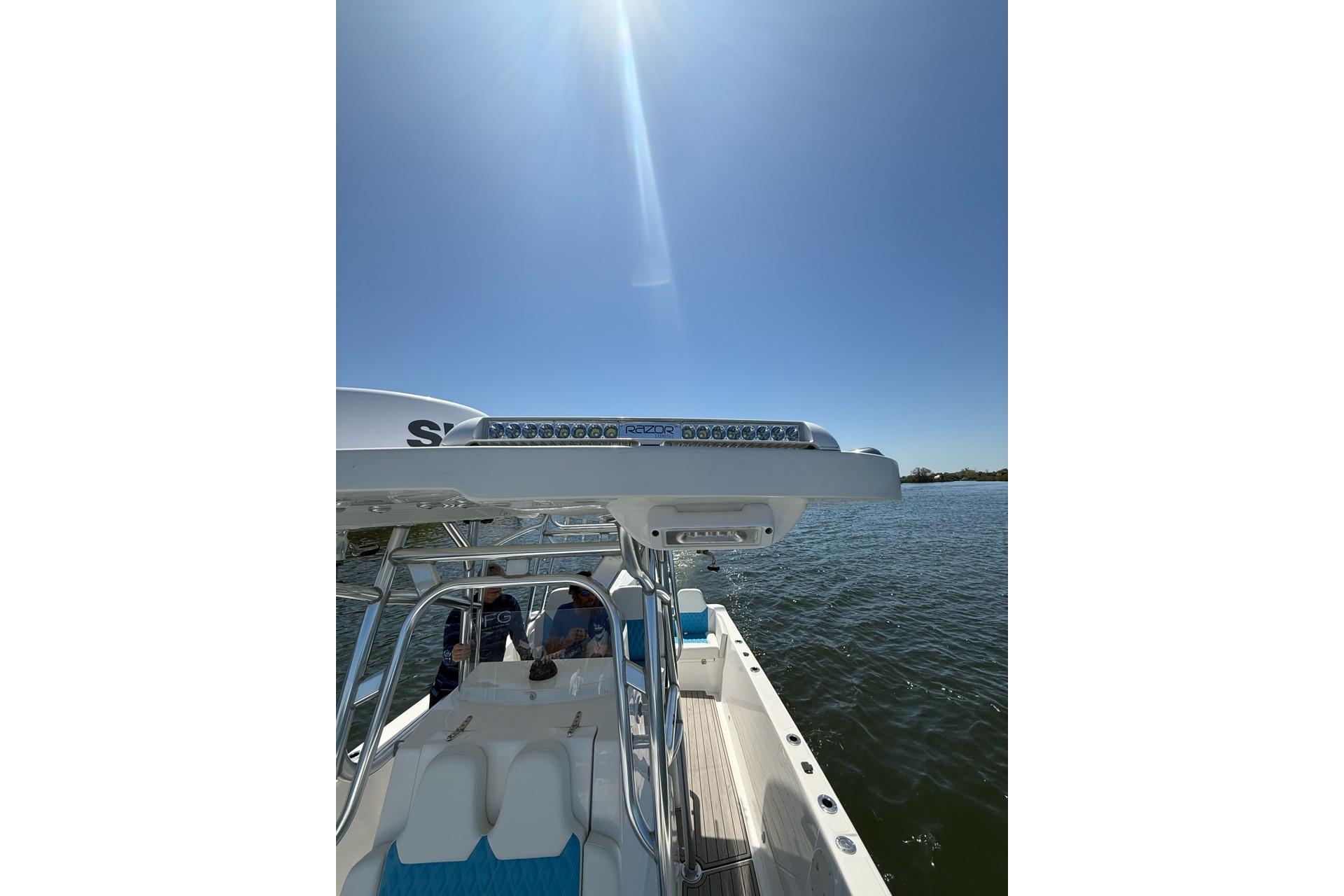 Custom Infusion 34 CC 2021 boat on water under clear blue sky.