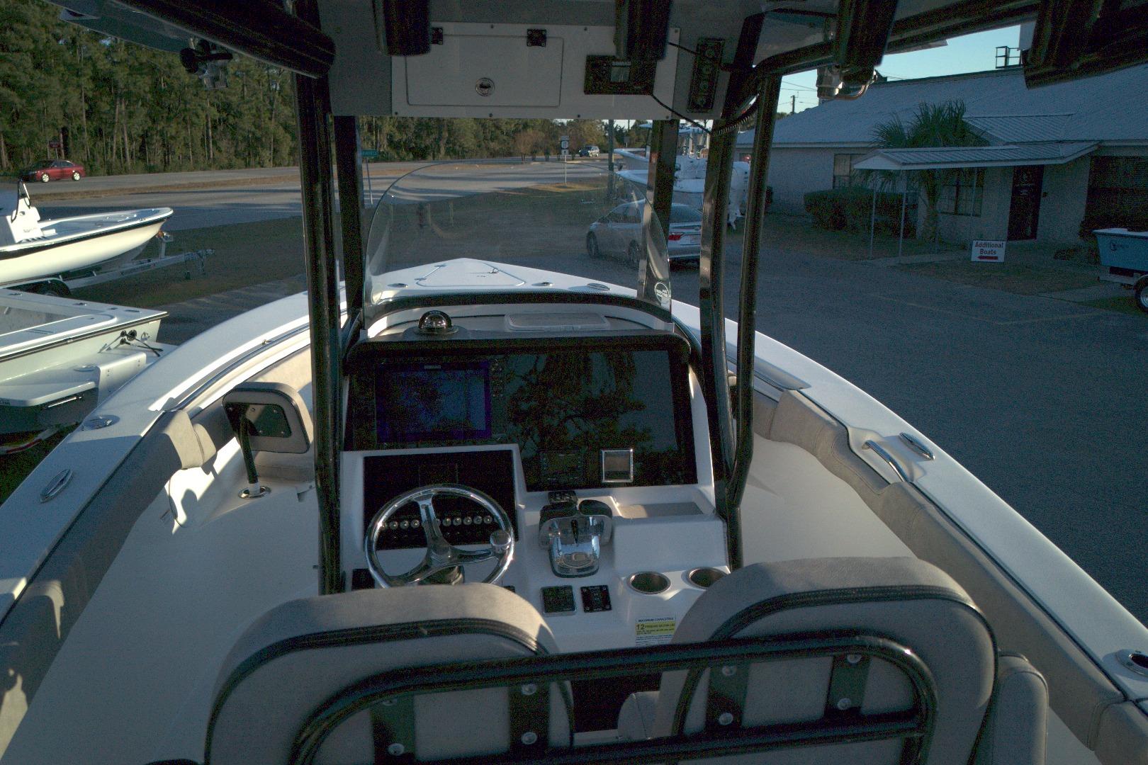 2021 Sea Pro 259 Center Console boat interior with steering wheel and navigation equipment.