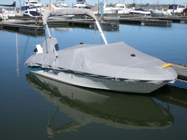 1992 Rinker Captiva 170 OB boat covered and docked in a marina.