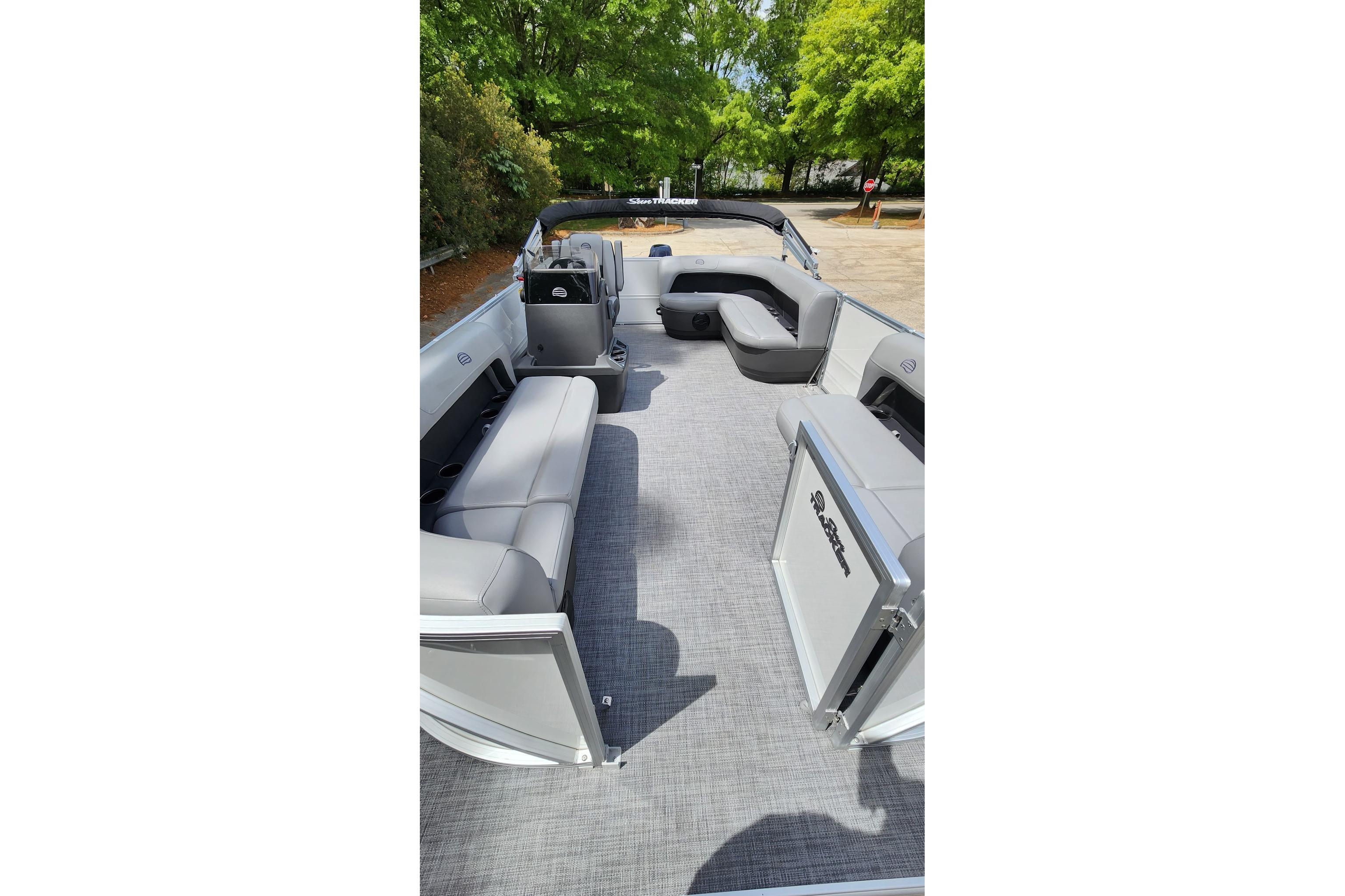2026 Sun Tracker Party Barge 16 DLX interior with gray seating and open deck space.