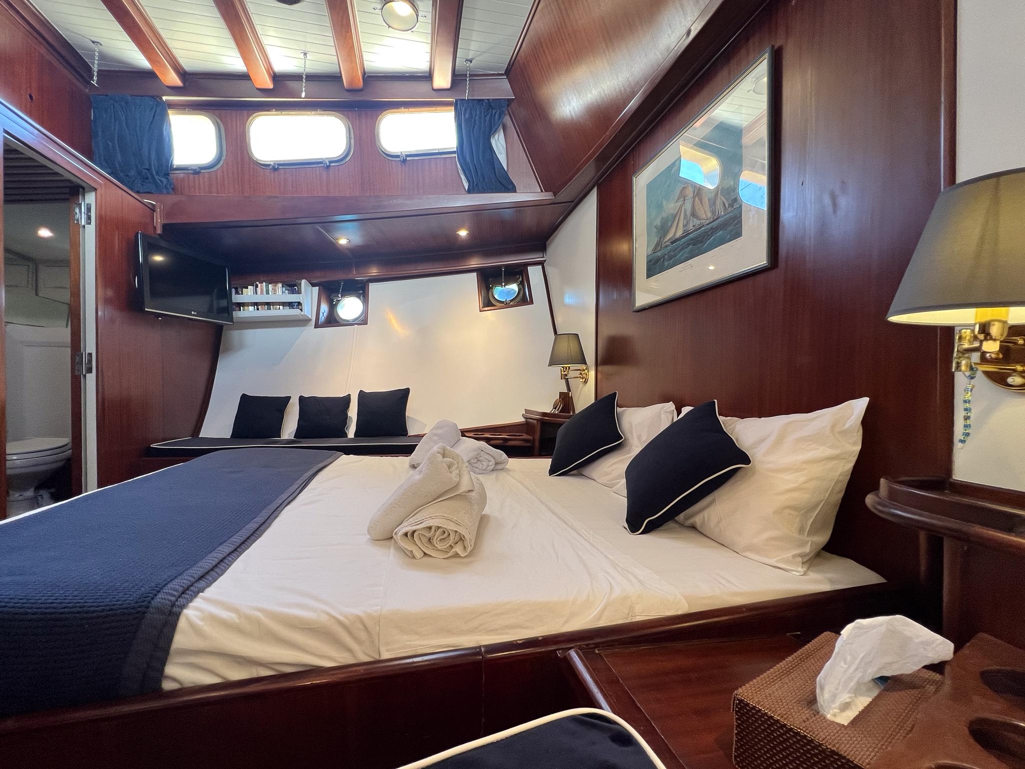 Luxurious cabin interior of a 1969 Custom Psarros Shipyard yacht with elegant wood finishes.