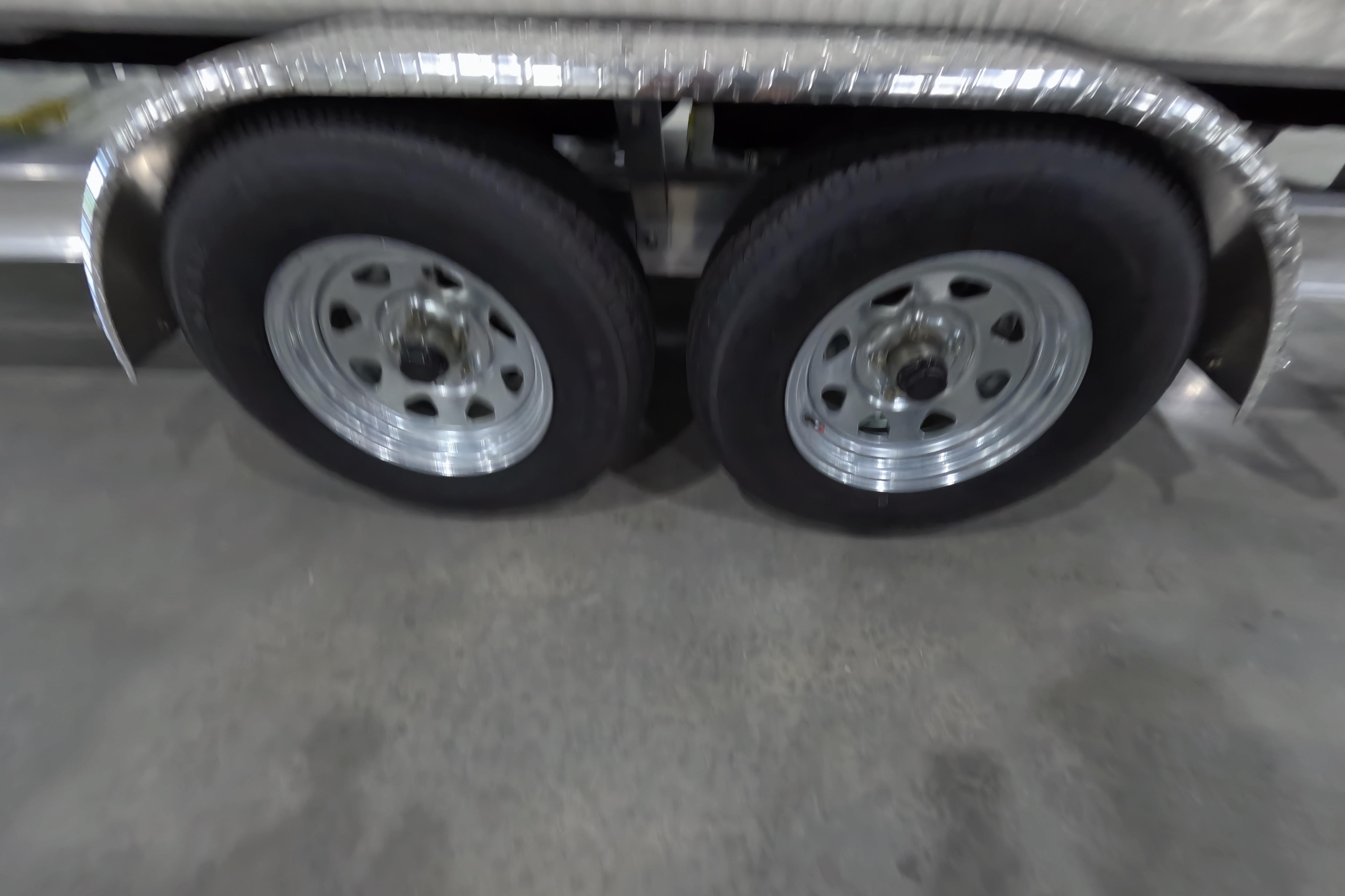 Dual wheels on a 2026 Skeeter SX230 trailer, featuring shiny metal rims.