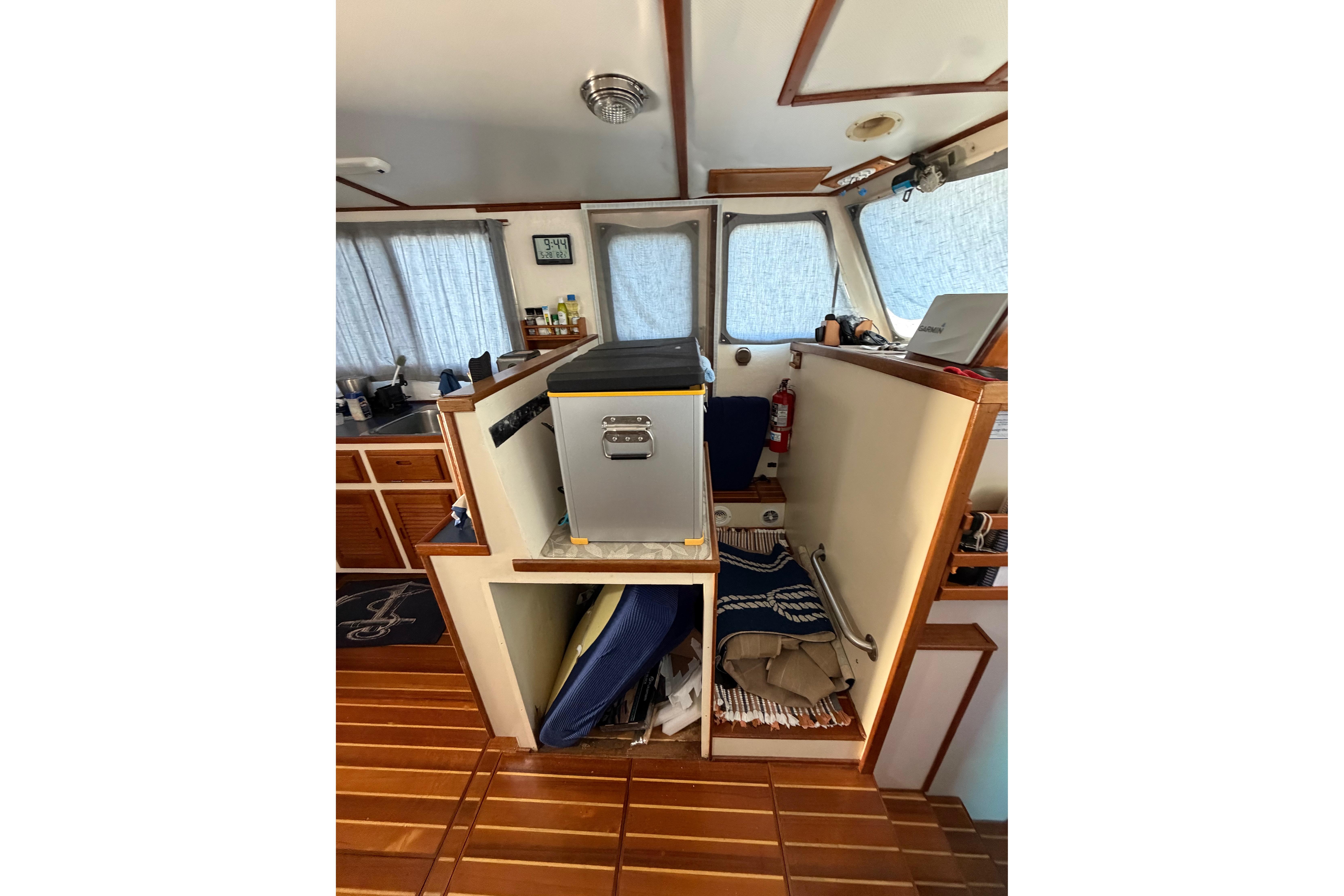 Interior of a 1997 Rosborough Trawler with wooden flooring and compact storage.