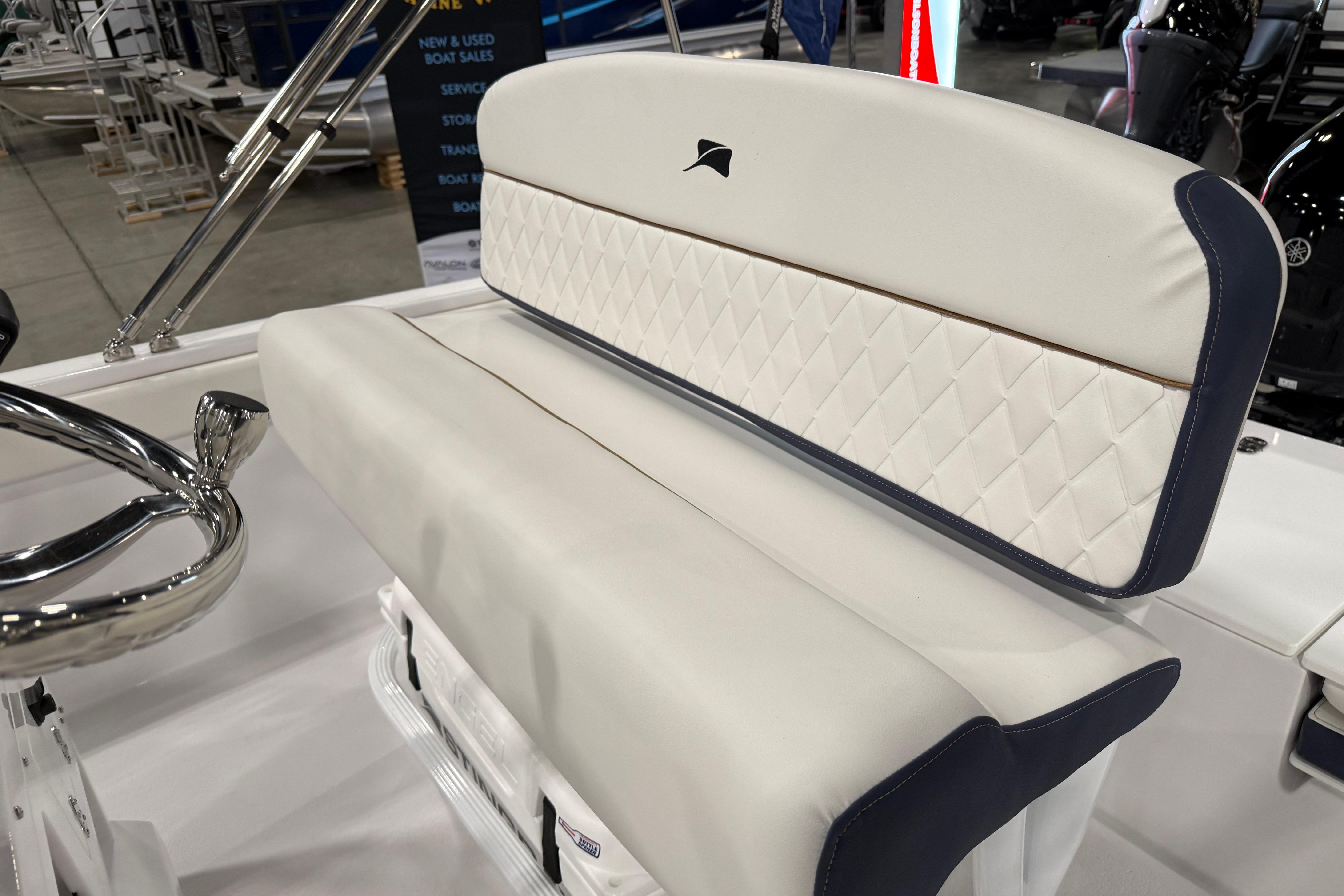 2026 Stingray 173 CC boat interior with white cushioned seating and chrome steering wheel.