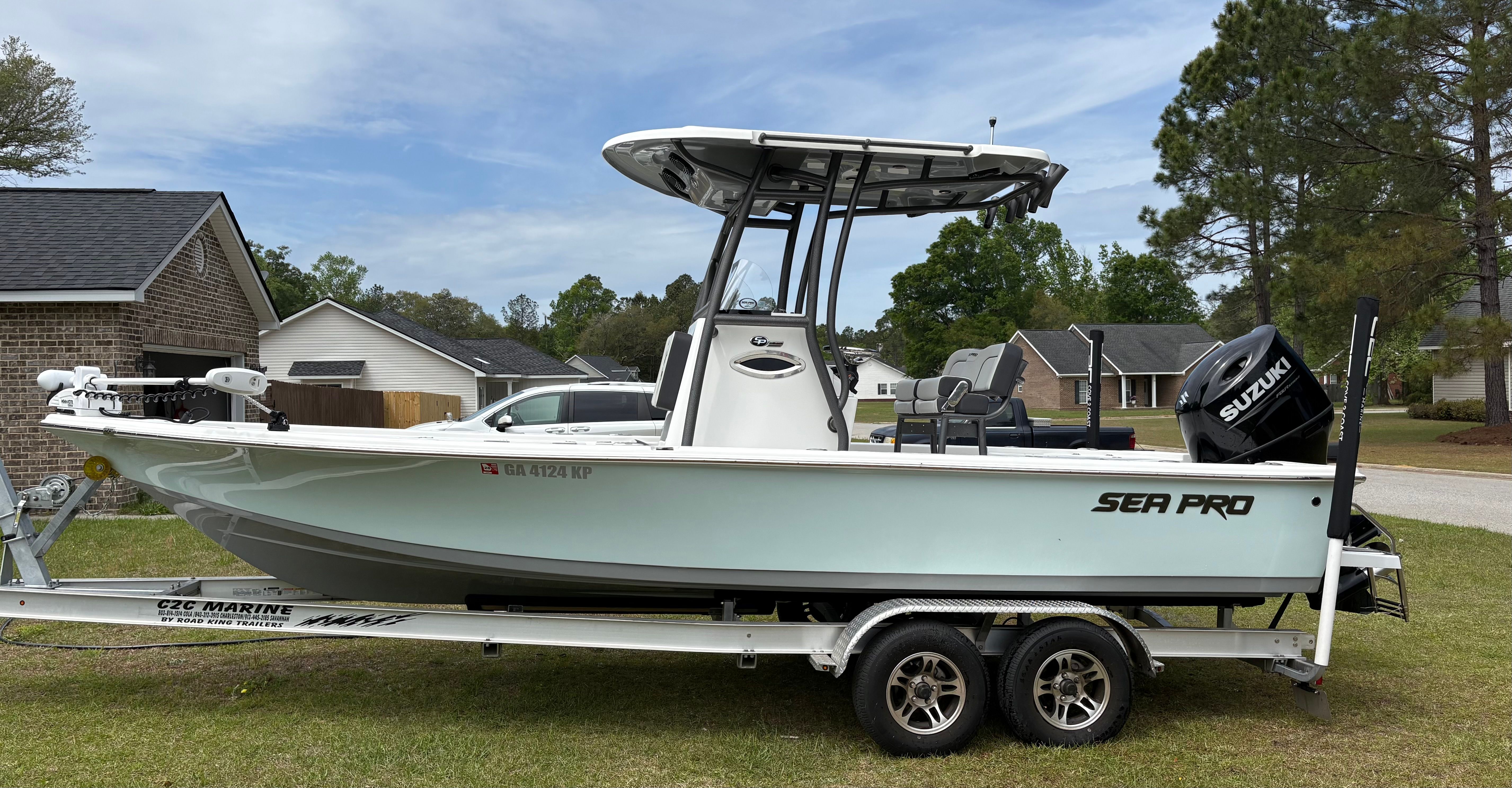 2025 Sea Pro 230 Bay boat on trailer in residential area.