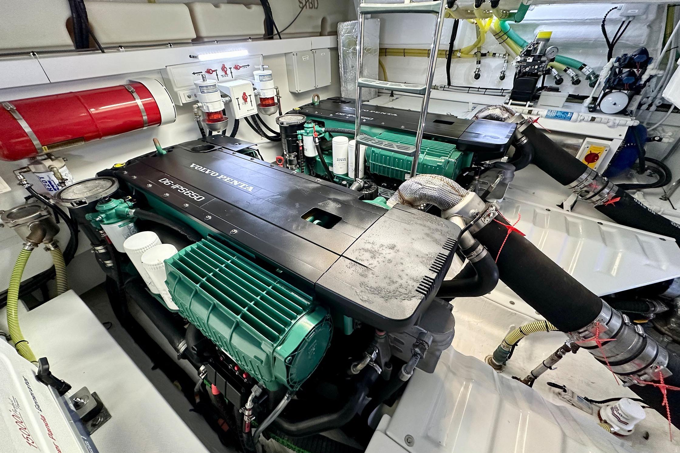 Engine room of 2022 Fairline Targa 50 GT with Volvo Penta engines and fire extinguisher.