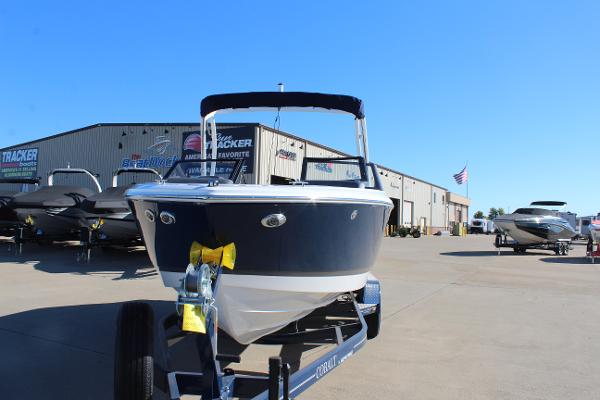 2025 Cobalt CS23 boat on trailer at dealership, sunny day.