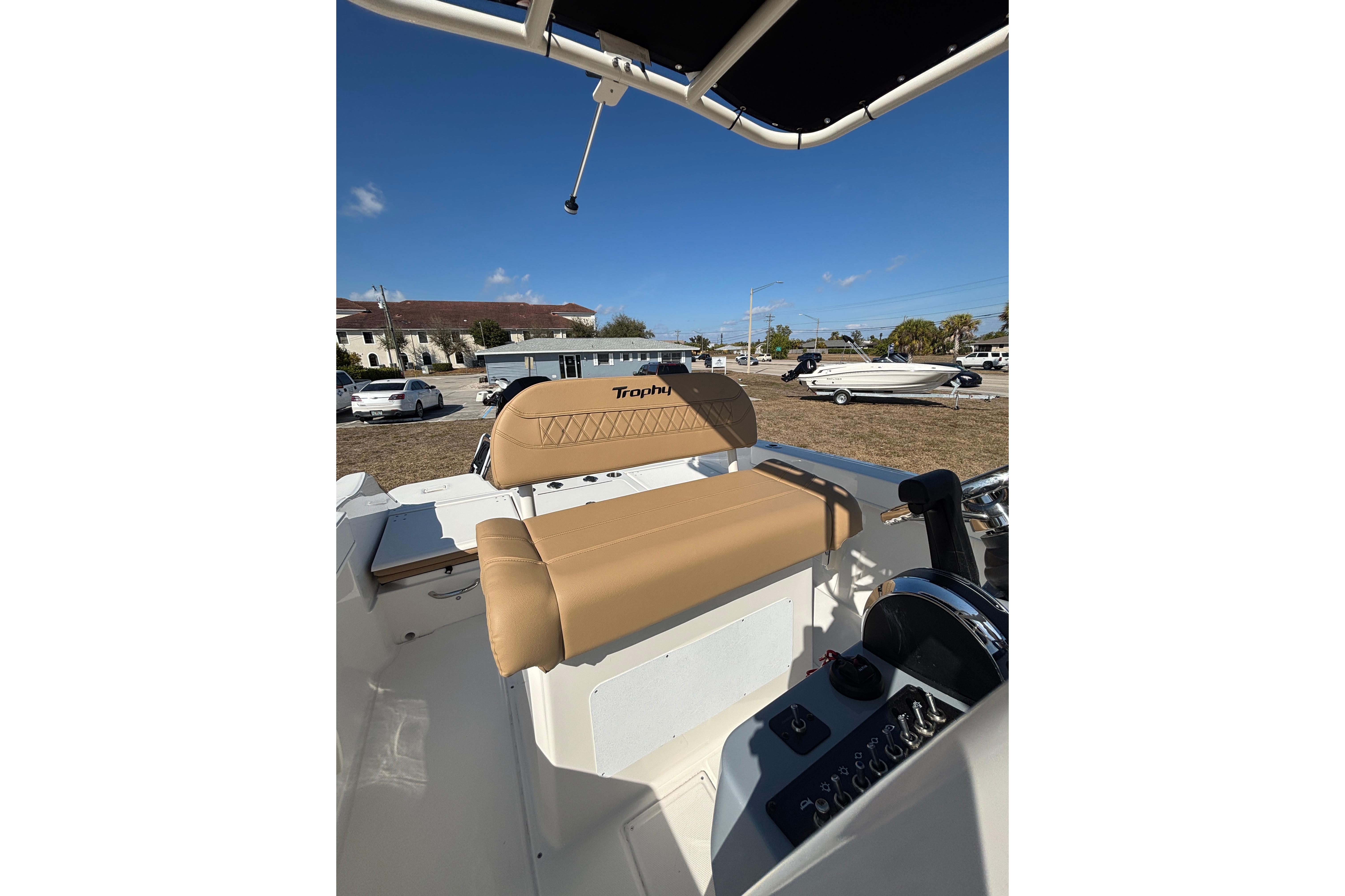 2026 Bayliner Trophy T22CC boat interior with tan seating and control panel.