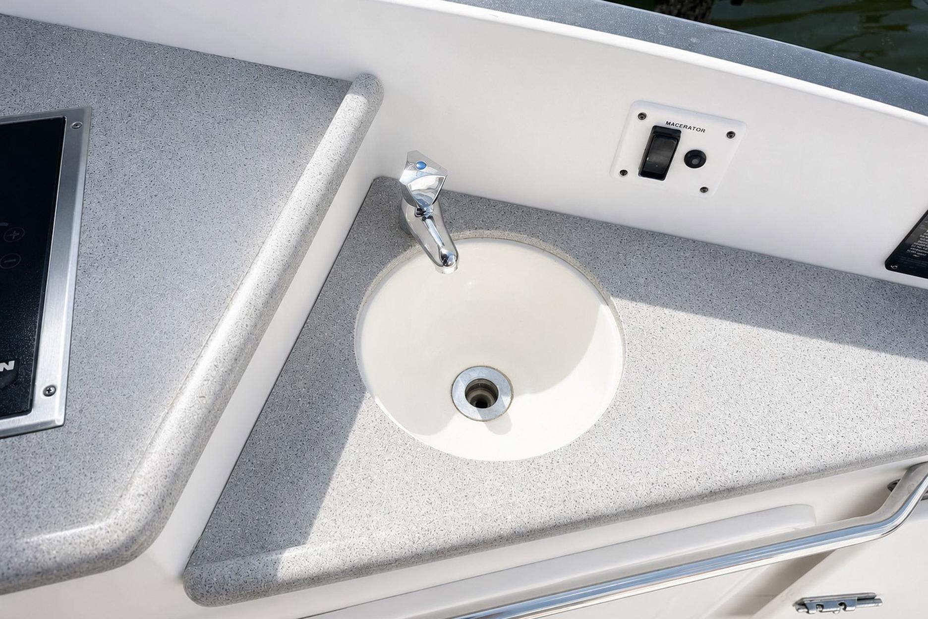 2012 Rinker 310 Express Cruiser LE boat sink and countertop detail.