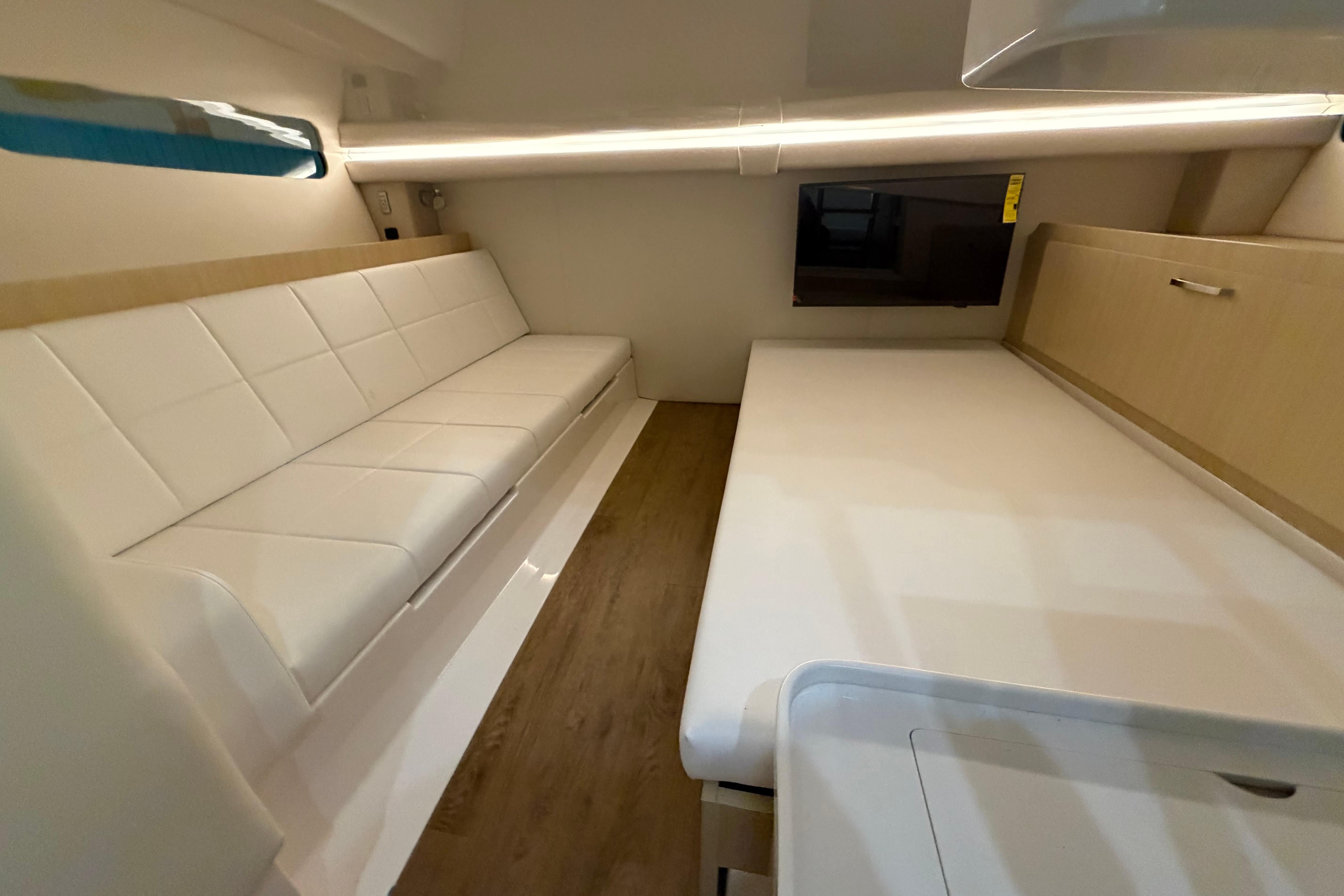 Modern interior of 2027 Regal 38 Surf boat with sleek white seating and wood accents.