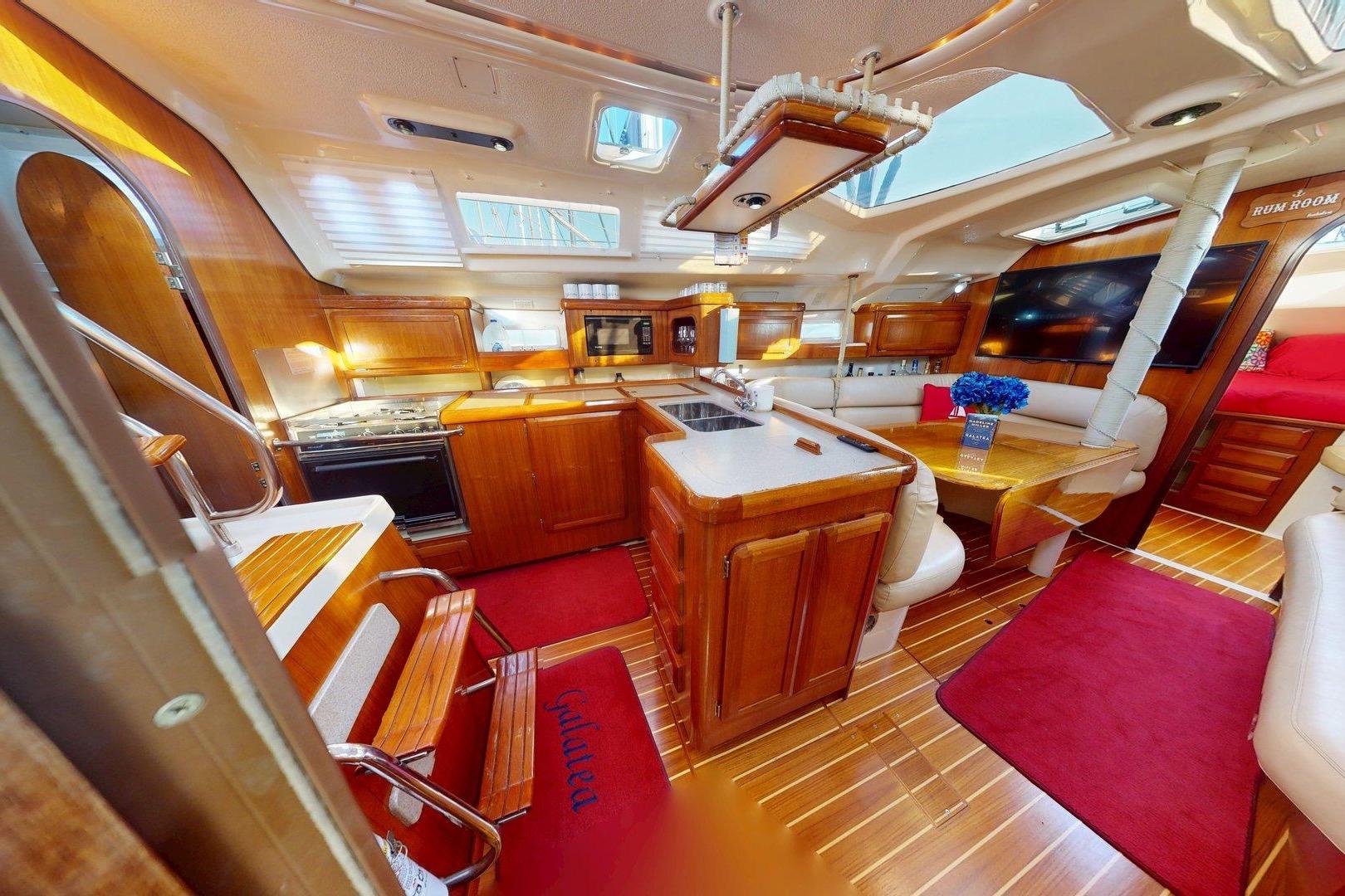 Luxurious interior of a 1997 Hunter Legend 40.5 yacht with wood finishes and modern amenities.