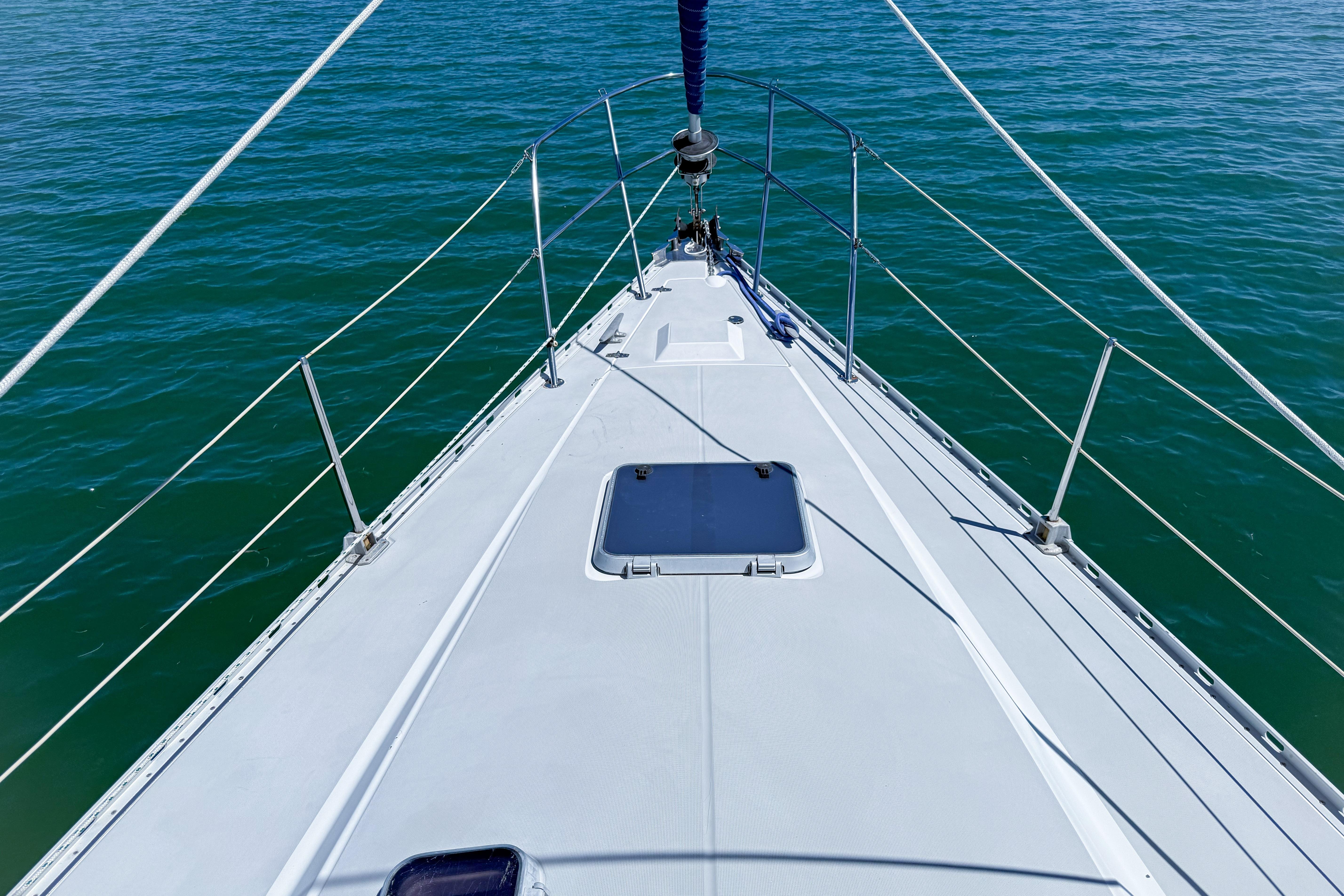Bow view of 1988 Oday 40 sailboat on calm blue water.