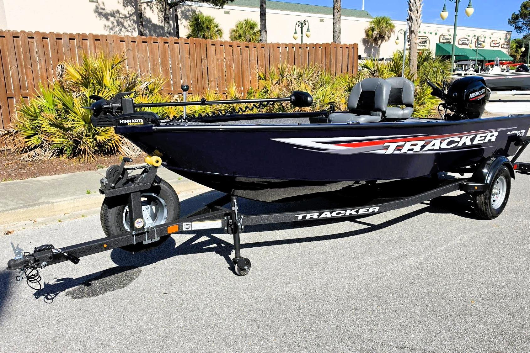 2026 Tracker Super Guide V-16 T boat on trailer, parked outdoors.