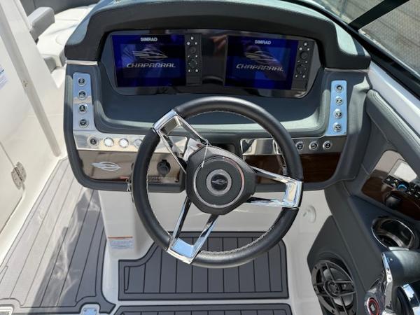 2023 Chaparral 267 SSX boat dashboard with dual displays and modern steering wheel.
