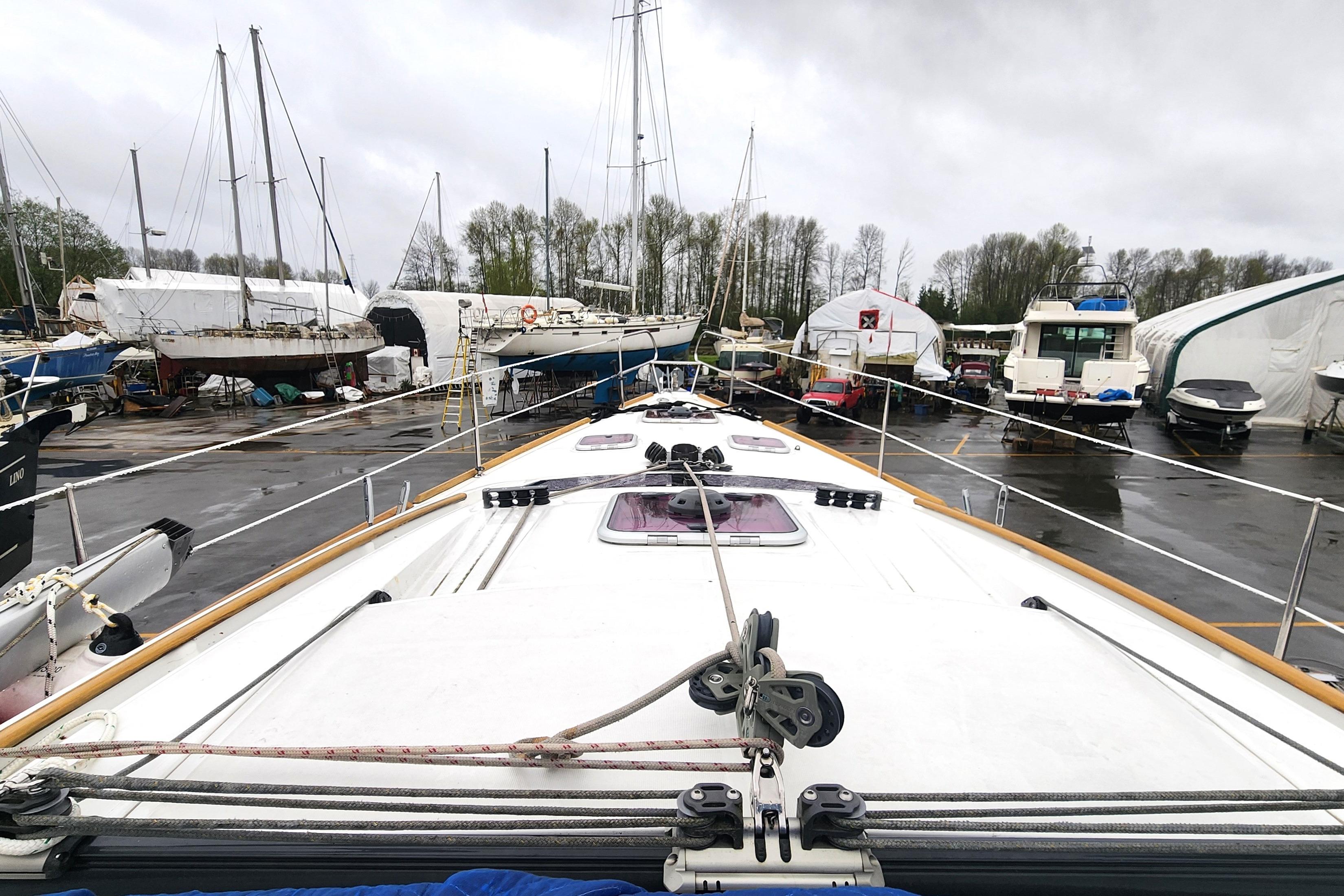 Beneteau Oceanis 40 sailboat, 2012 model, docked in a marina with overcast skies.