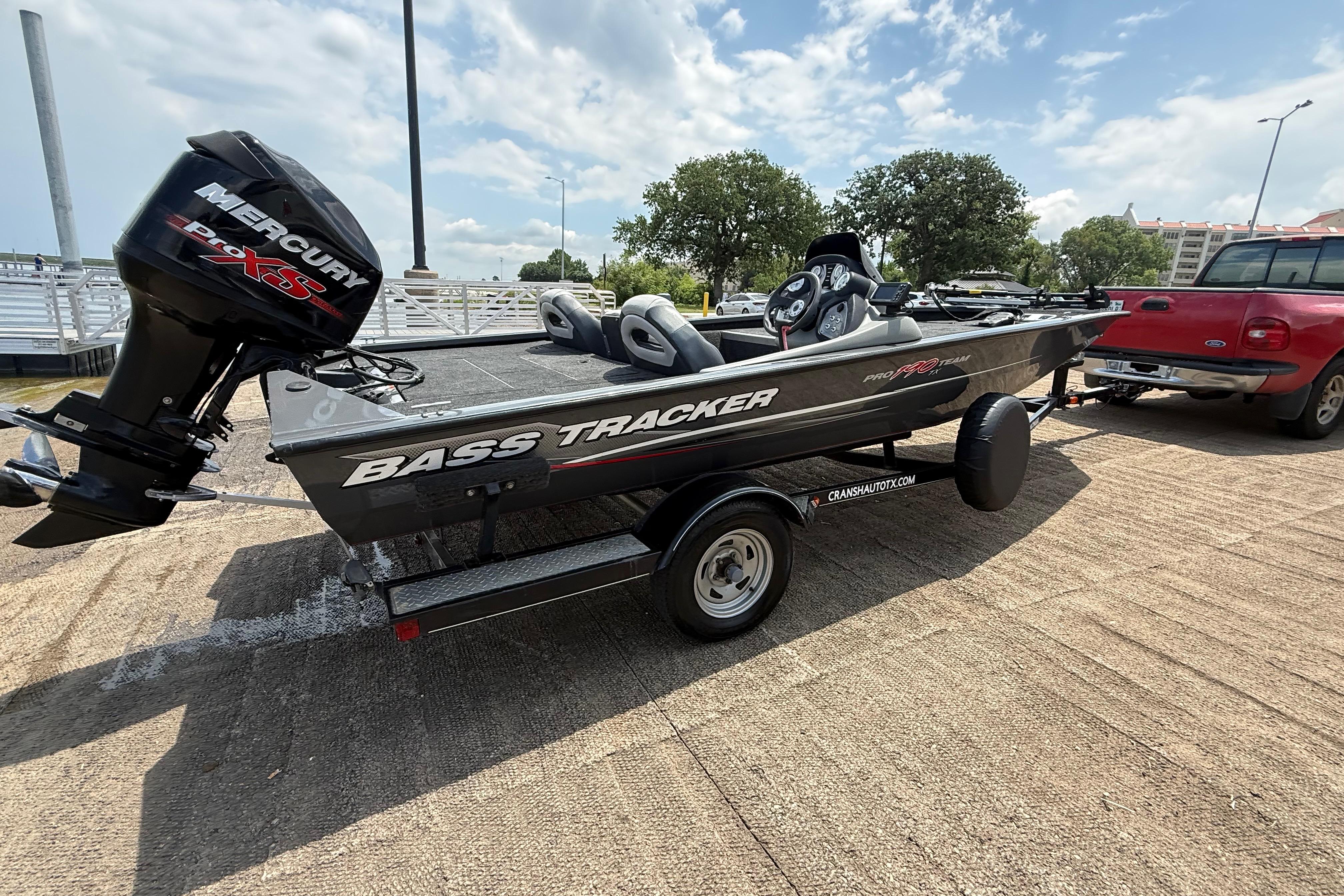 2015 Tracker Pro Team 190 TX boat with Mercury engine on trailer, parked outdoors.