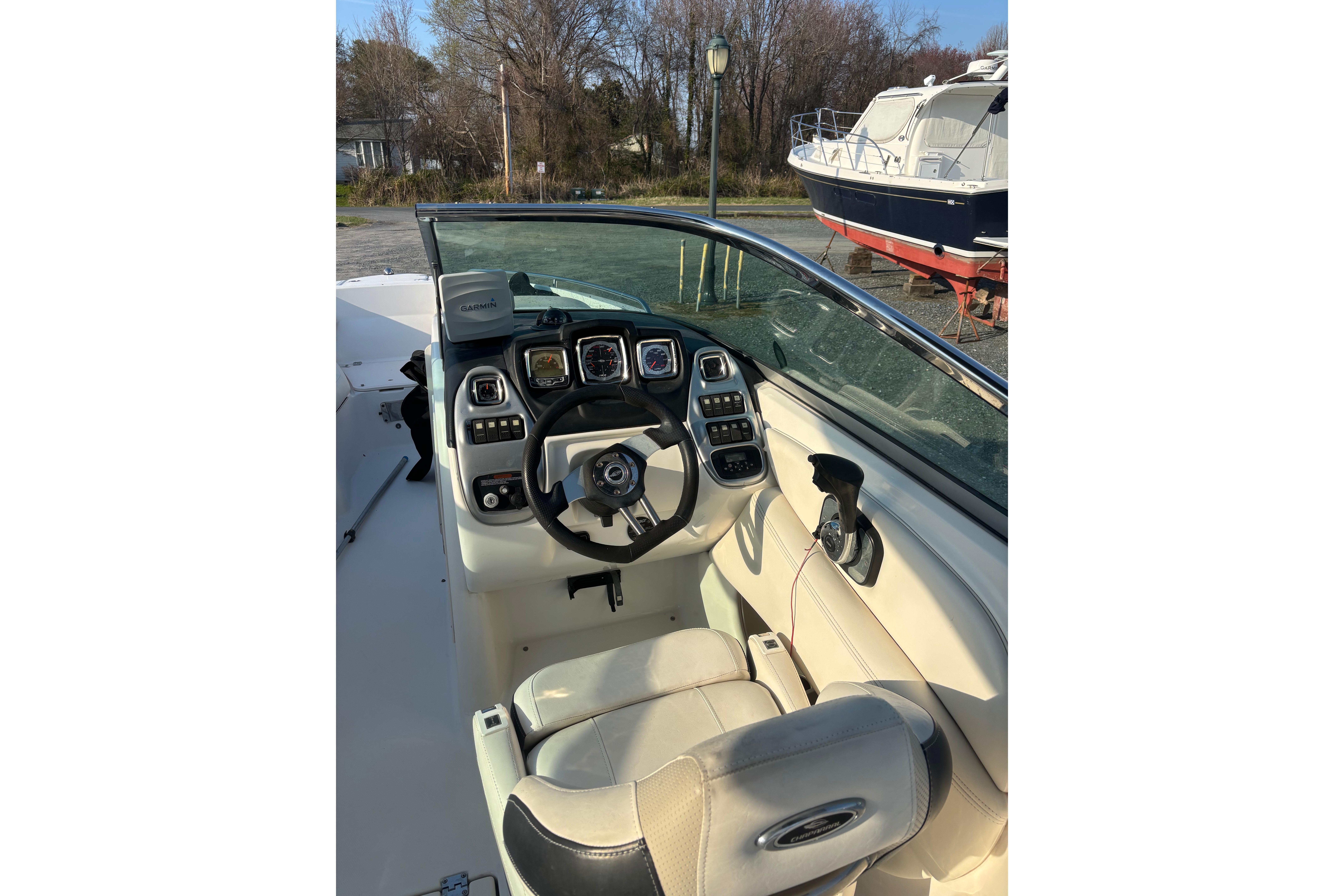2012 Chaparral 267 SSX boat cockpit with steering wheel and control panel.