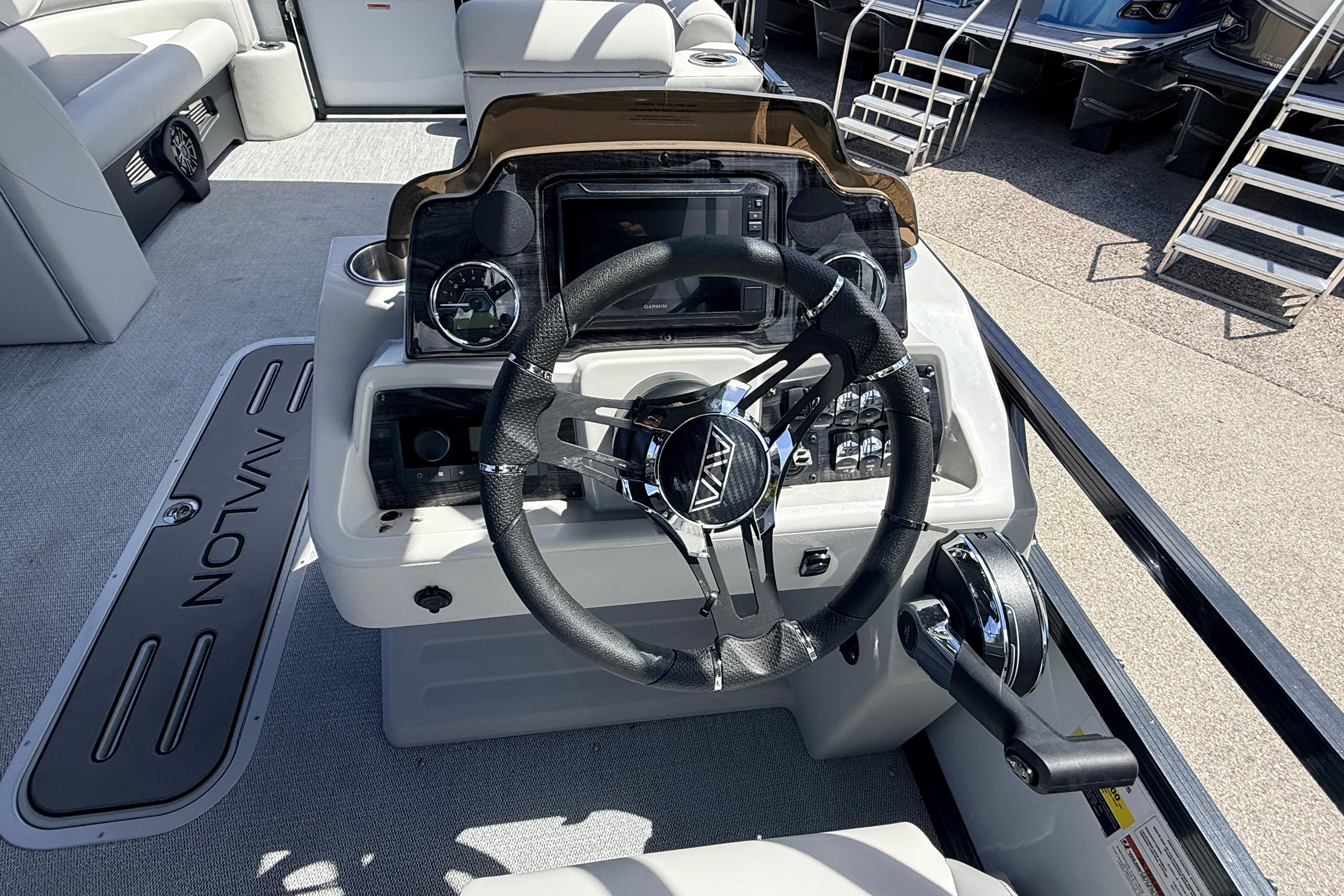 2026 Avalon 2385 Venture boat dashboard with steering wheel and control panel.