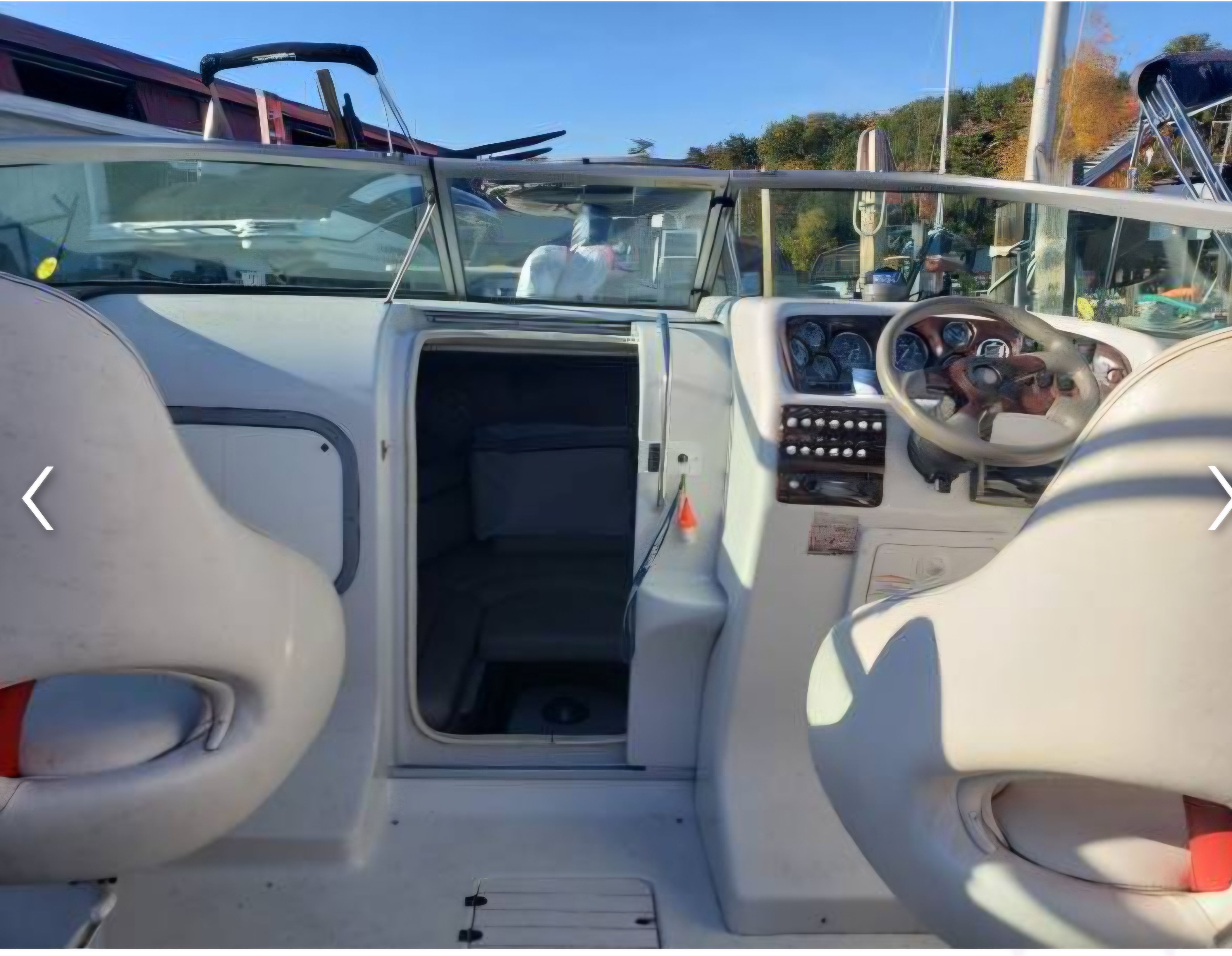 Interior of a 2003 Crownline 215CCR boat with steering console.