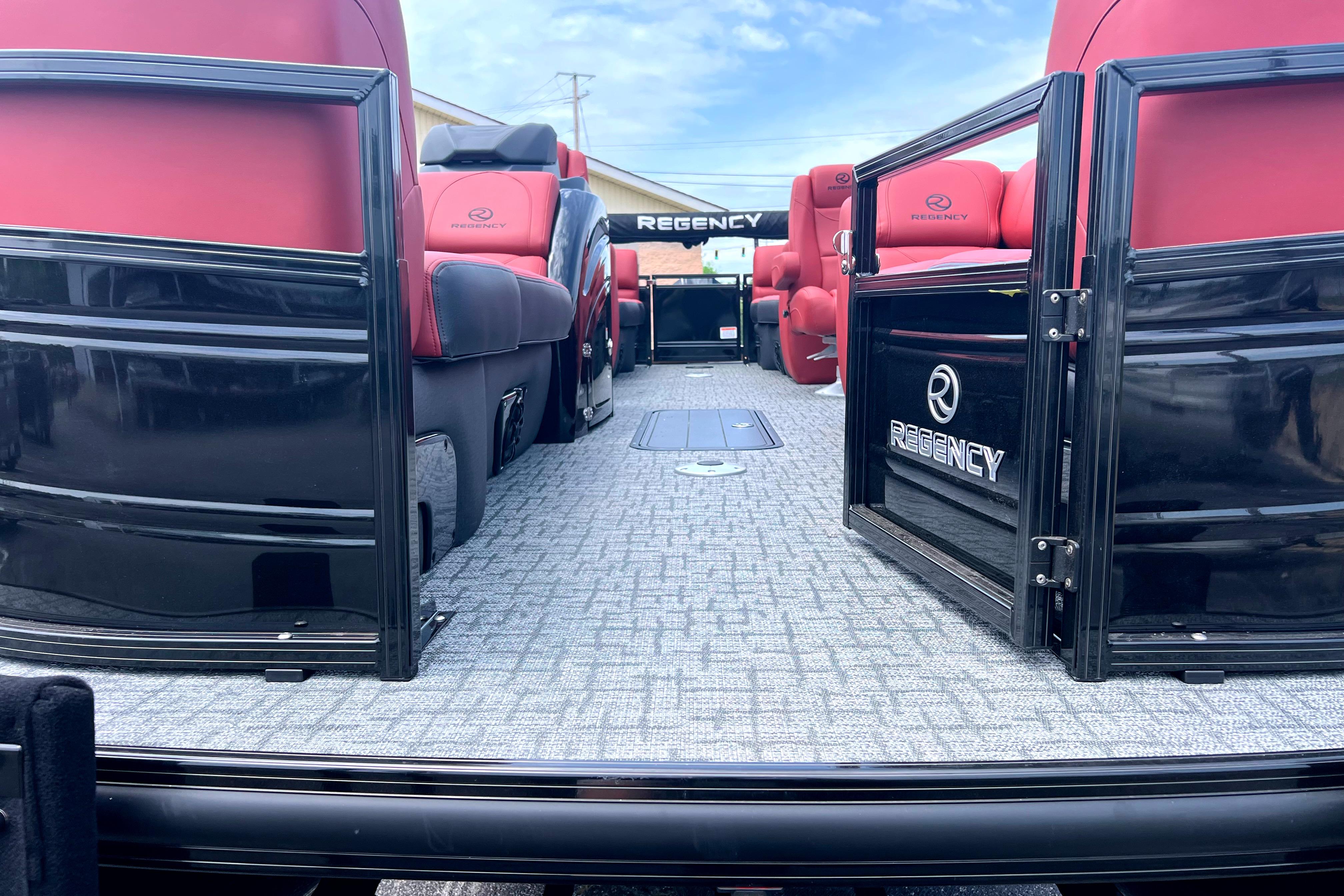 2026 Regency 230 DL pontoon boat interior with red seating and gray flooring.