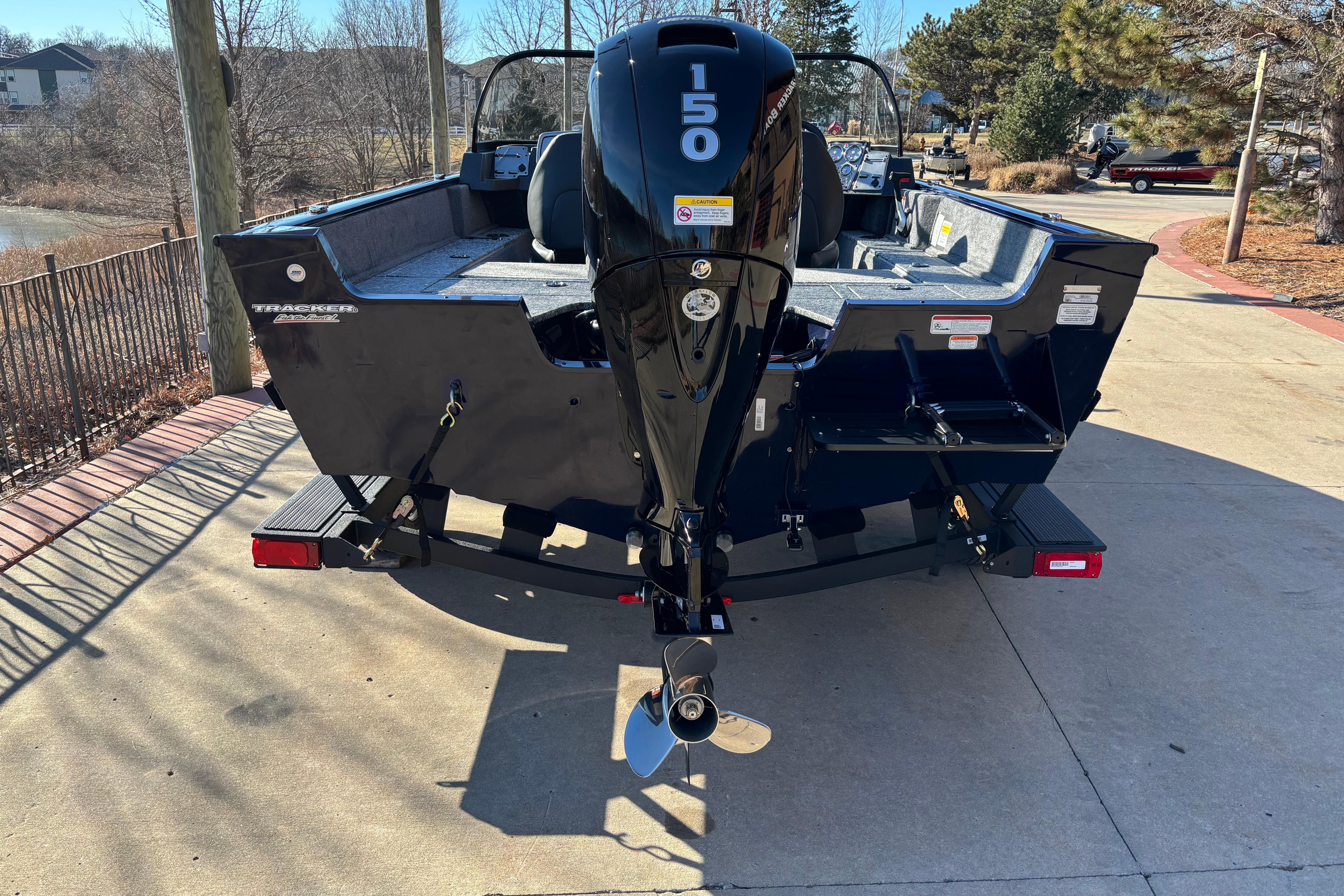 2026 Tracker Pro Guide V-175 Combo boat with 150 HP engine, parked outdoors.
