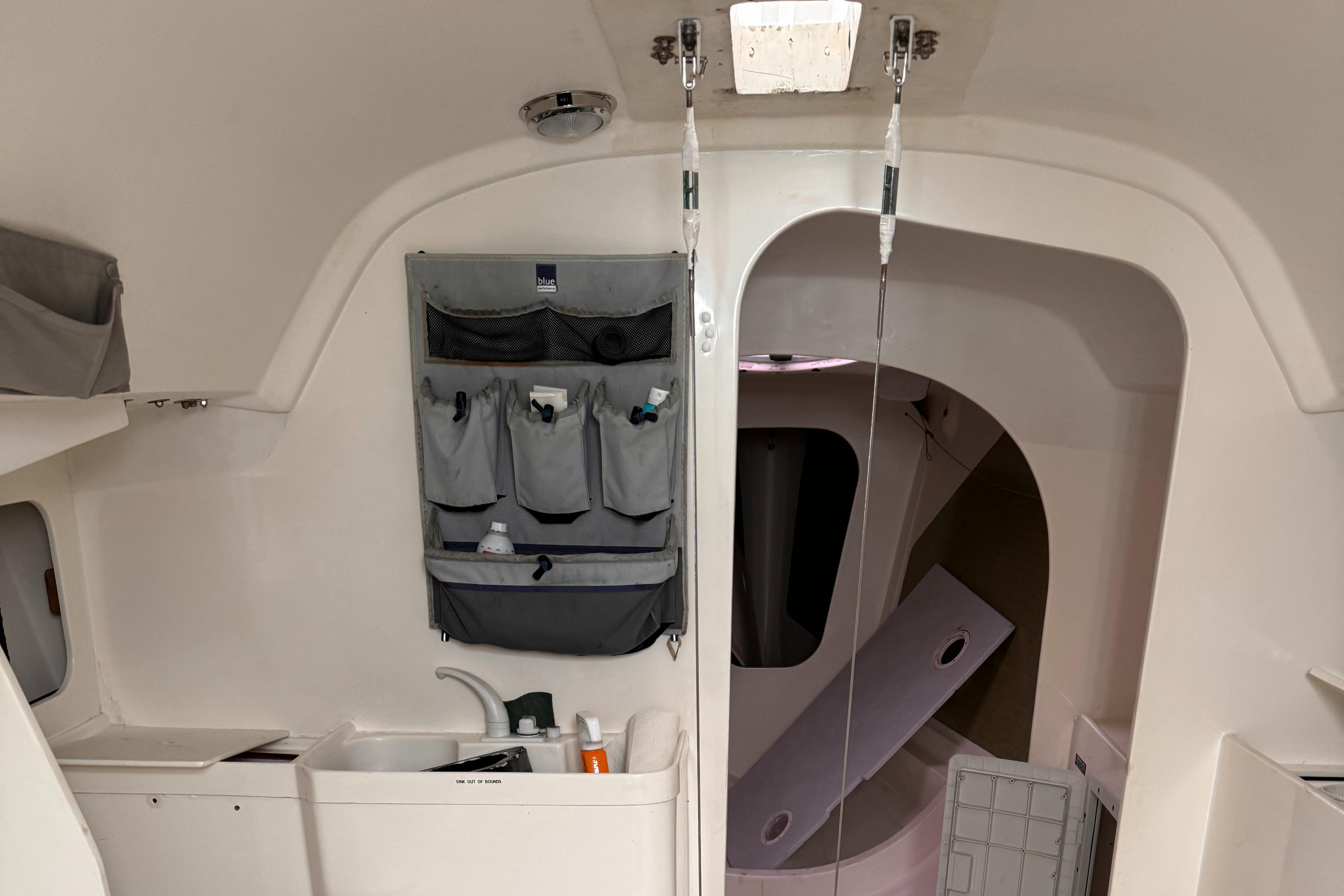 Interior of a 2002 Farr 40 sailboat, featuring a compact sink and storage area.
