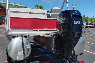 2026 Sun Tracker Bass Buggy 16 XL Select with Mercury 50 outboard motor in parking lot.
