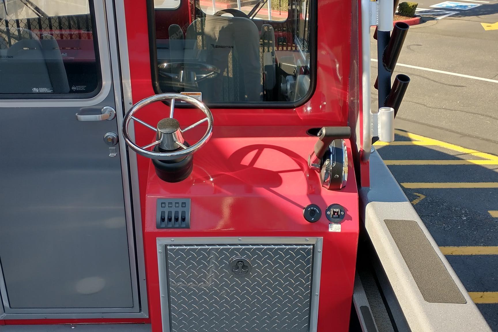 2024 Spartan 220 Maximus Pro boat helm with steering wheel and controls.