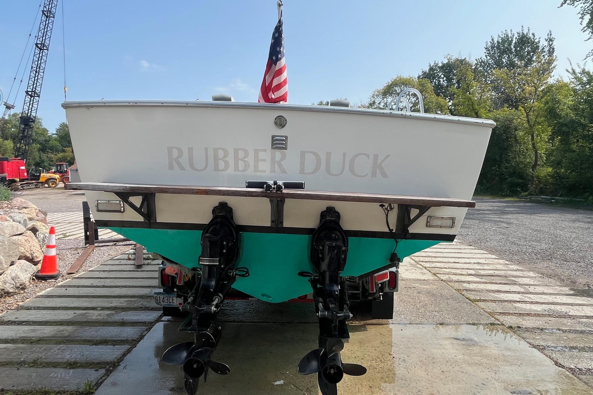 1975 Bertram 26 Moppie boat named "Rubber Duck" on a trailer with American flag.