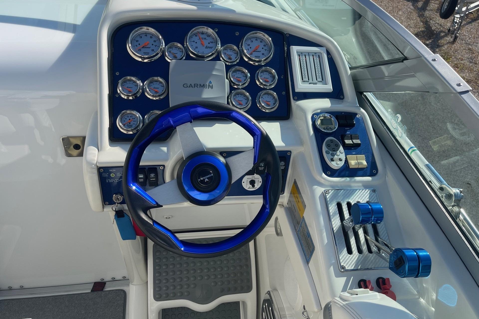 2004 Formula 382 FASTech boat dashboard with blue accents and Garmin navigation system.