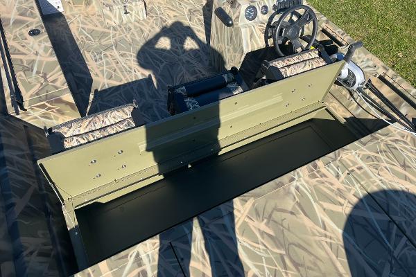 2025 Lowe Roughneck 2070 SC boat interior with camouflage design and steering console.