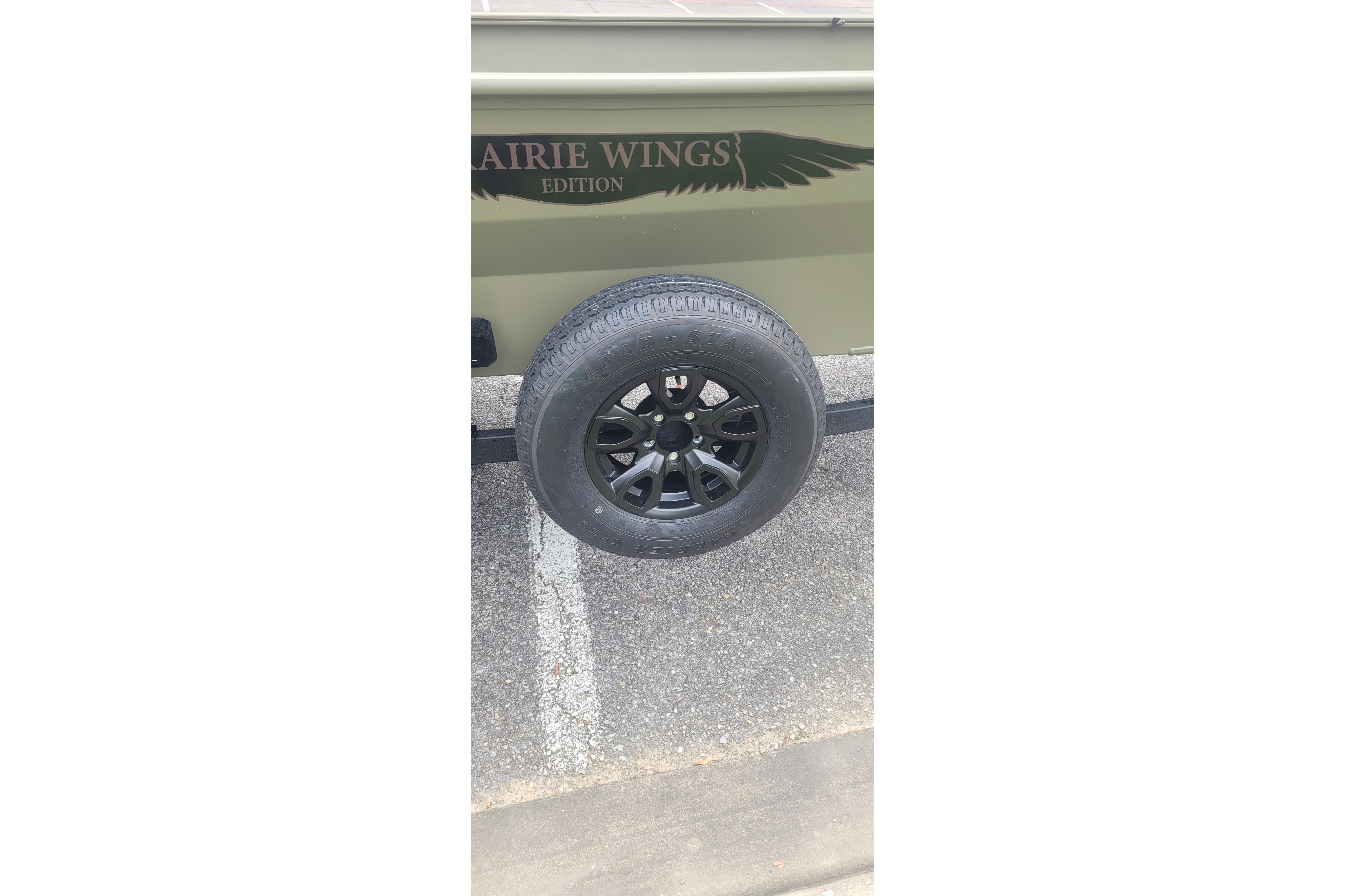 2026 Tracker Grizzly 1650 T Prairie Wings Edition trailer wheel and branding.