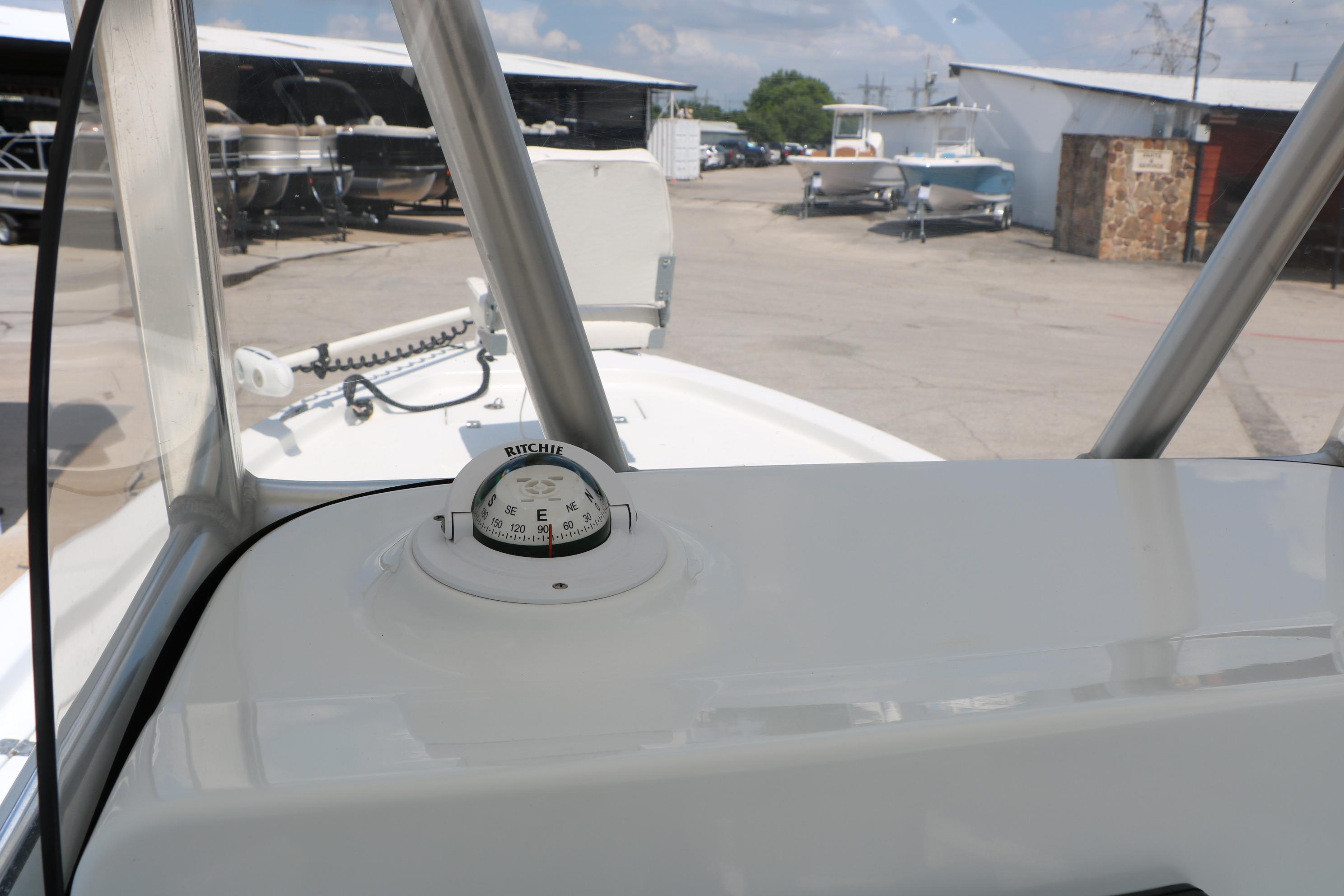 2015 Sea Hunt BX 22 BR boat dashboard with compass, parked in marina.