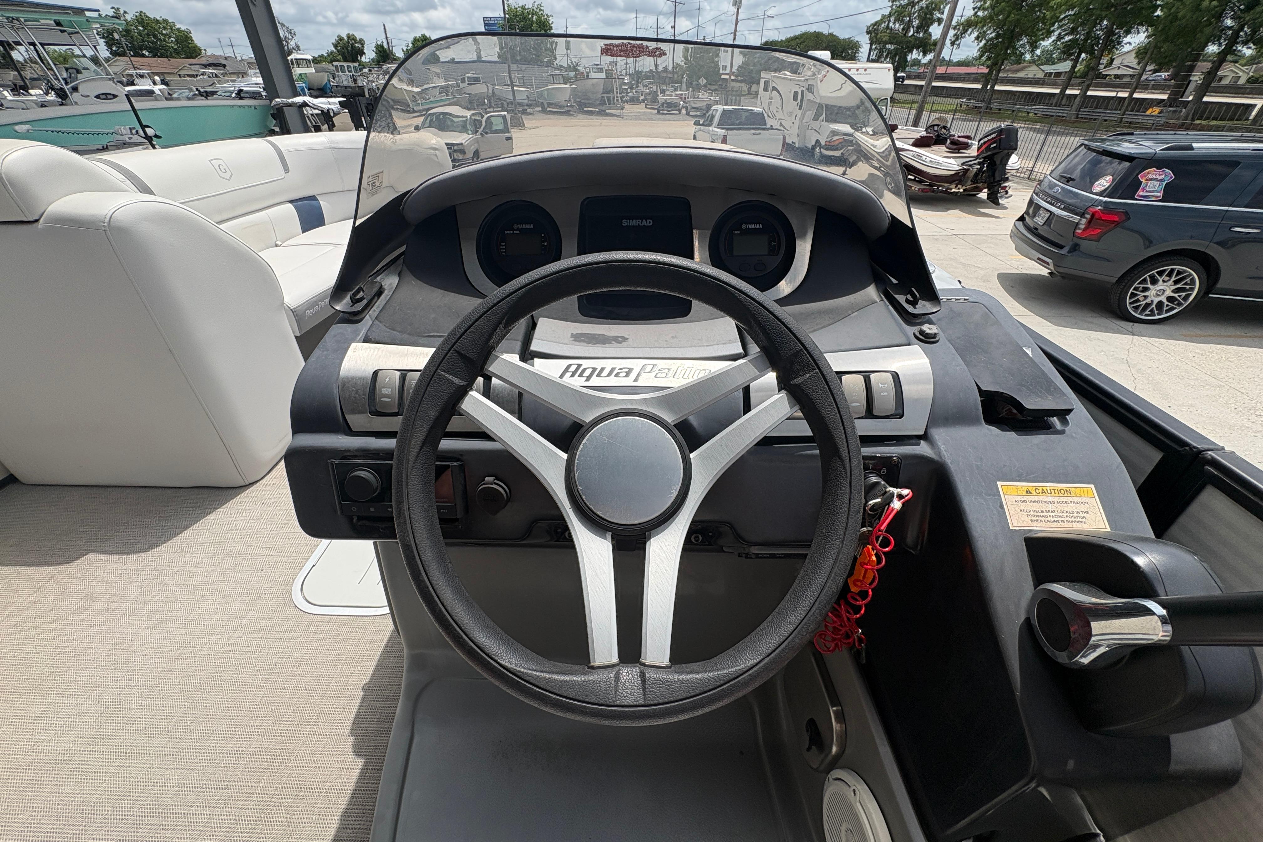 2019 Godfrey Aqua Patio boat dashboard with steering wheel and controls.