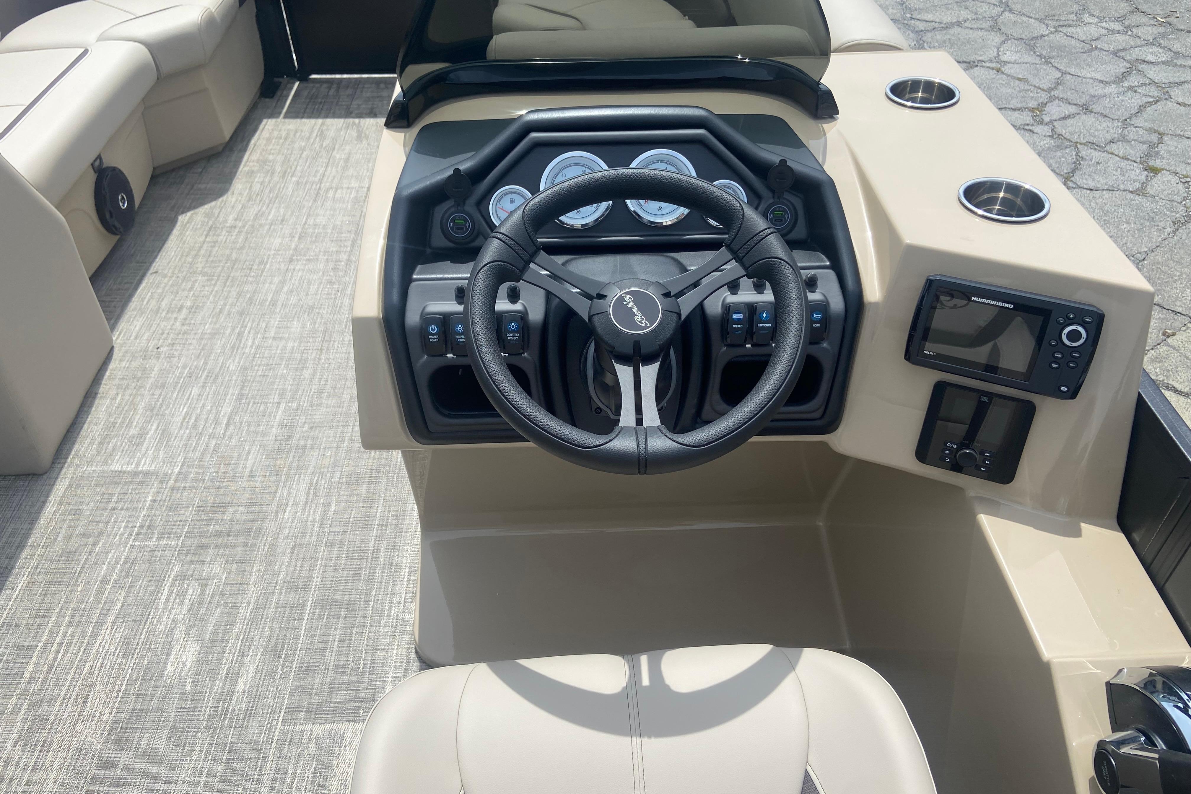 2026 Bentley Pontoons Legacy 223 Navigator dashboard with steering wheel and controls.