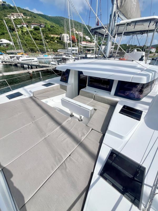 2023 Bali 4.6 yacht with spacious deck and seating, docked in a scenic marina.